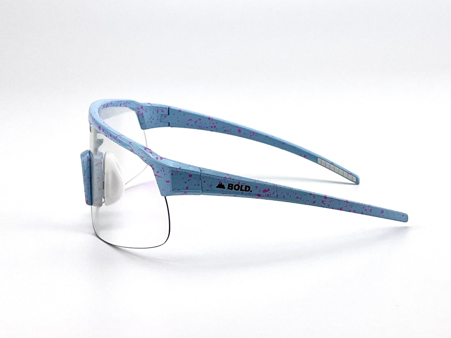 BOLD Zippy Photochromic Sunglasses by boldouterwear in light blue with purple speckles, a single curved transparent lens, and thick frame. Black logo on side. Lightweight and ideal for MTB, ski, or lifestyle use. Plain white background.