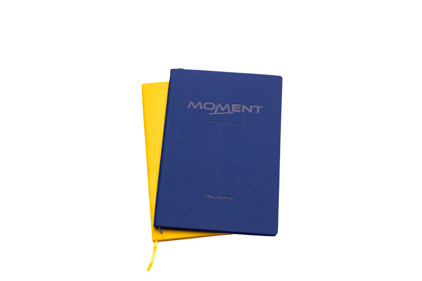 Two closed journals overlap on a white background. On top is the Moment Pickleball Practice & Play Mindfulness Journal by Moment Pickleball, dark blue with embossed text. Underneath, a yellow journal shows its color and part of a yellow ribbon bookmark.