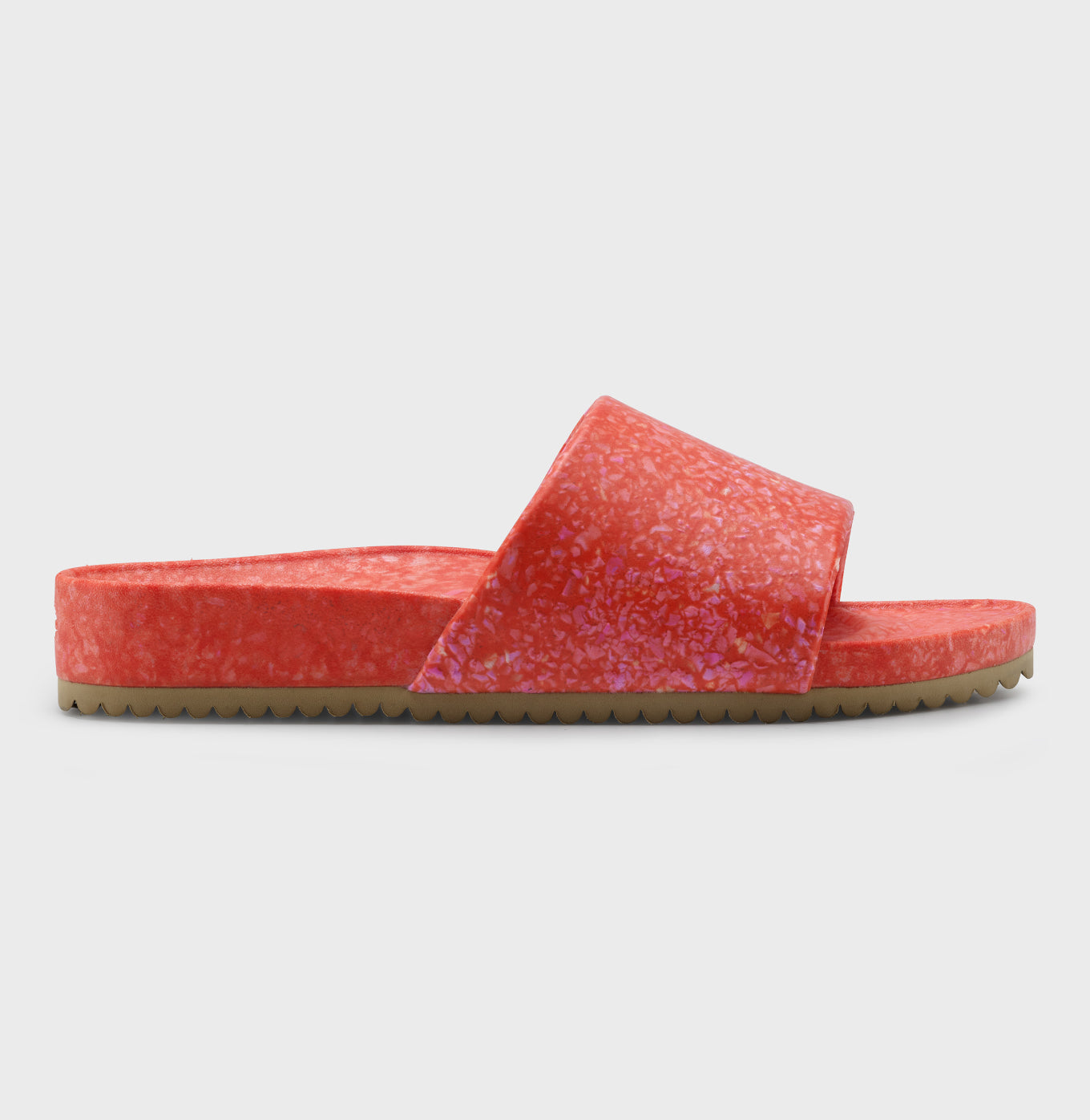 The Blumaka Fleks® East Beach Slide is a single sandal with a chunky sole for support, featuring a thick red and pink strap and footbed with a brown, ridged bottom for grip. The vibrant colors stand out against the plain white background.