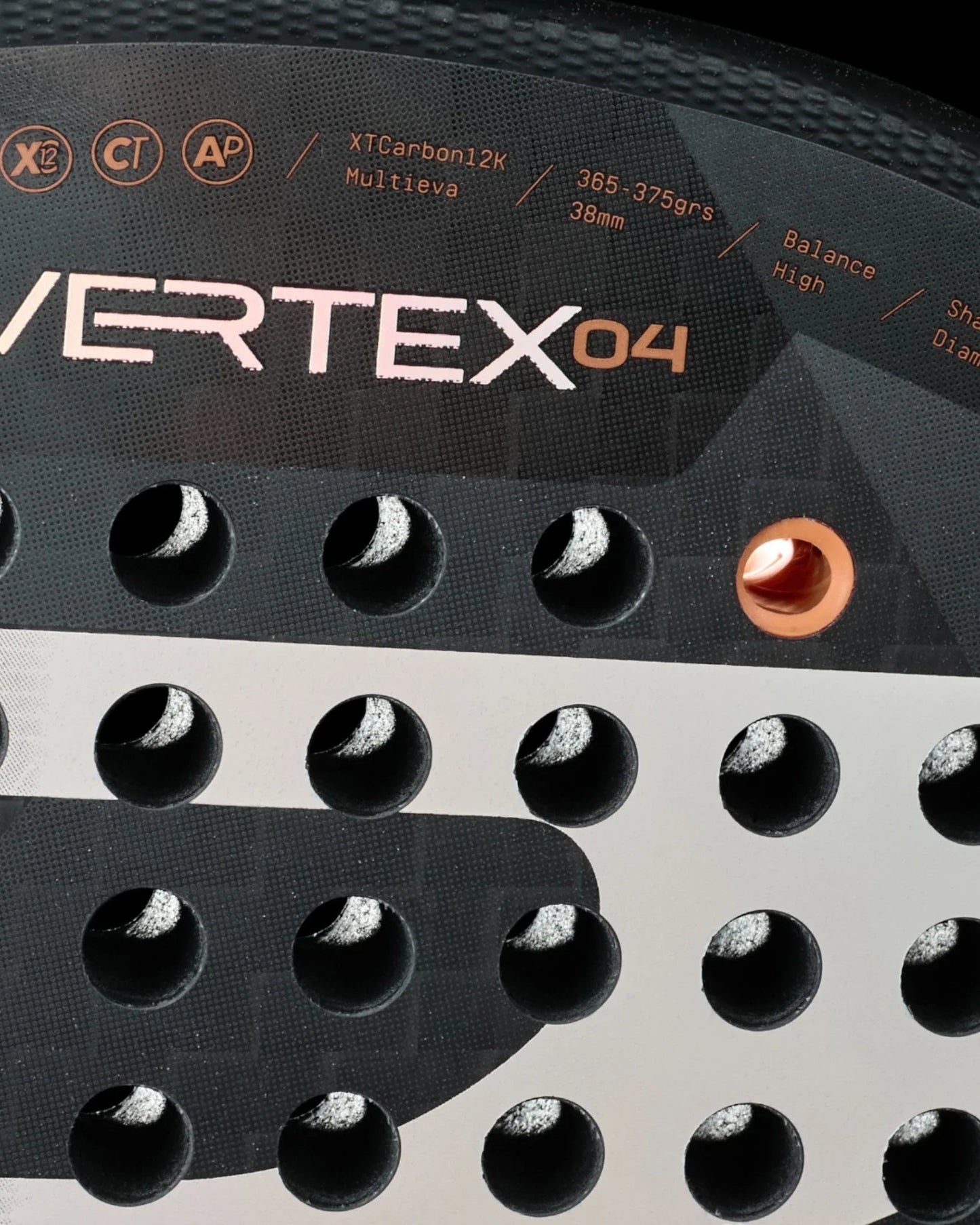 Close-up of a Bullpadel Vertex 04 Juan Tello padel racket by Padel USA, featuring circular holes, Multieva and XTCarbon12K text, and technical icons for balance and diamond shape—ideal for professional padel players.