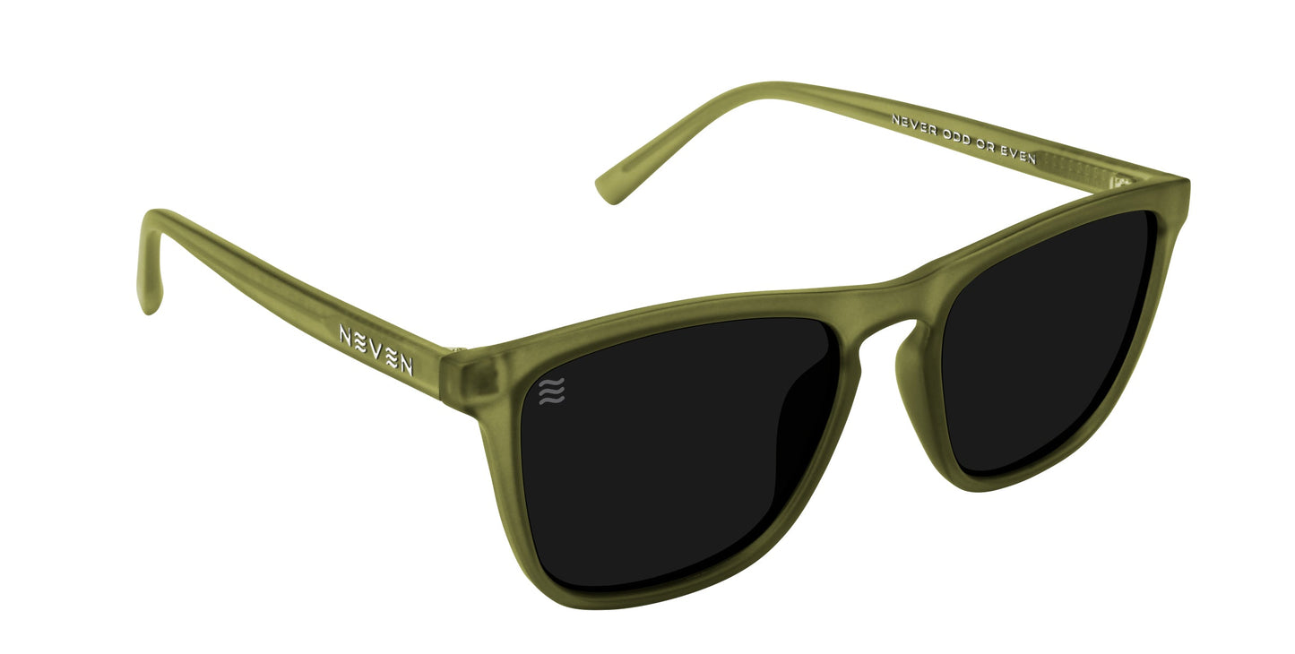 Fir sunglasses by Neven Eyewear feature matte olive green, slight cat-eye frames with black polarized UV400 lenses. The brand name is printed in white on the temples. Shown angled on a white background, highlighting the left side and front.