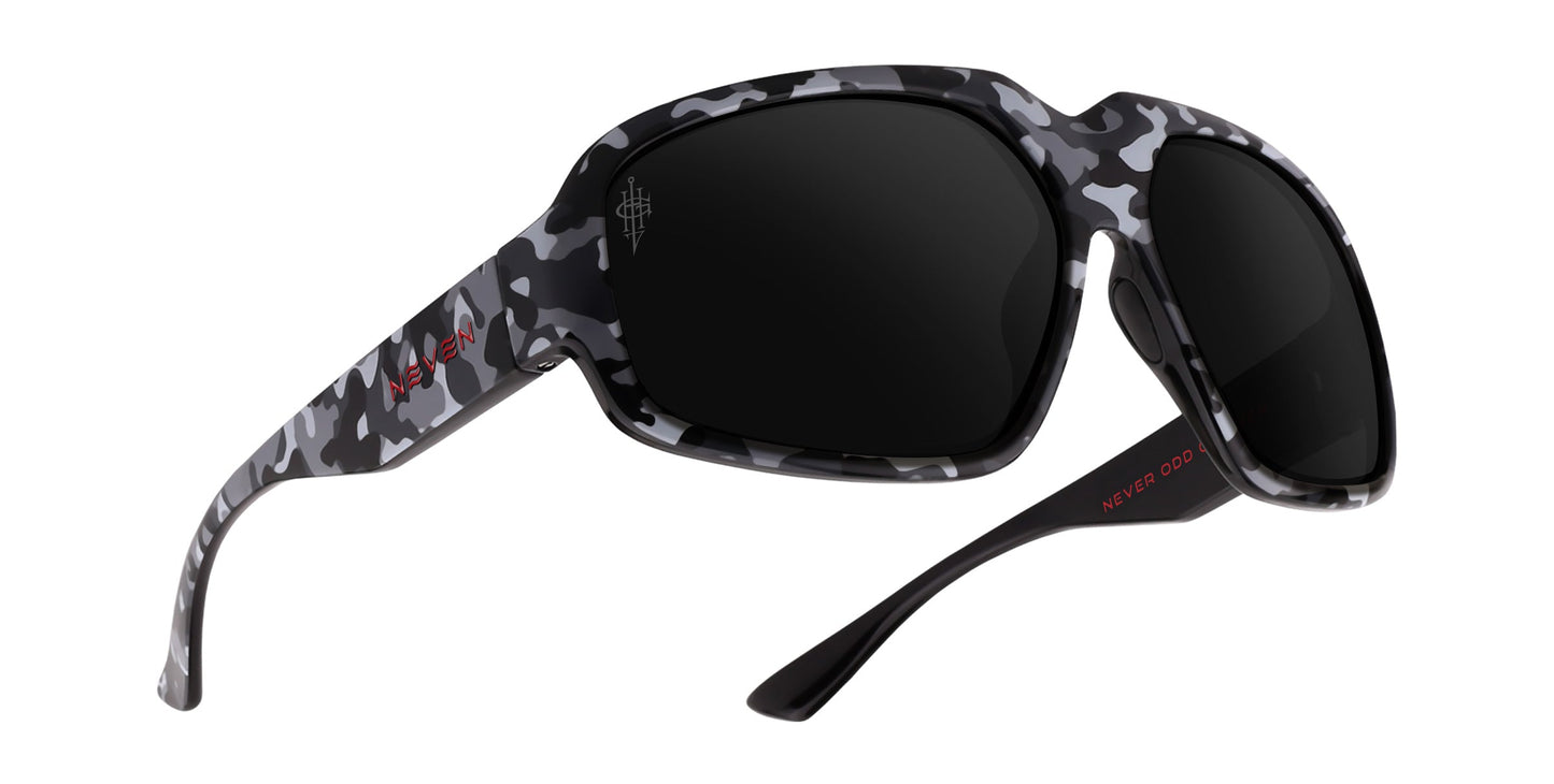 The A.W.O.L. sunglasses by Neven Eyewear feature a thick, rectangular black, white, and gray camo frame with dark rectangular lenses and red text on the left inner temple arm, displayed angled on a white background.