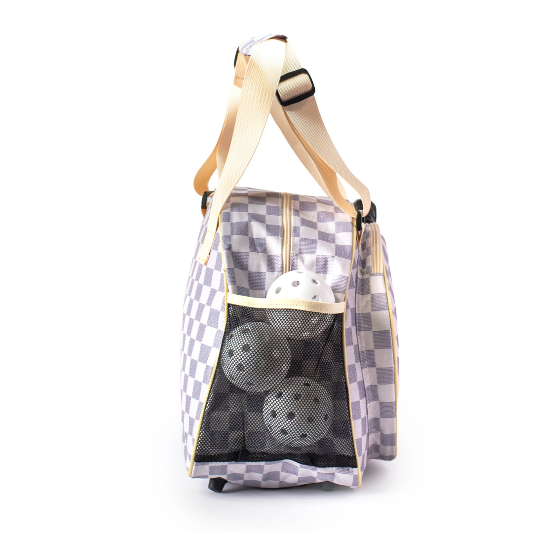 The Pik'le'Ball Sports Checkered Chic Tan Premium Women's Pickleball Bag is a stylish option for women, featuring a ball inside.