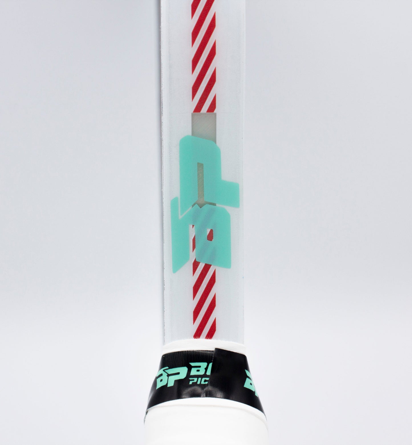 Close-up of a pickleball paddle with diagonal red stripes and a turquoise geometric symbol at the center. The Bodhi Performance Premium Edge Tape - CLEAR protects the edge, and the BP-branded cap is visible. Background is plain white.