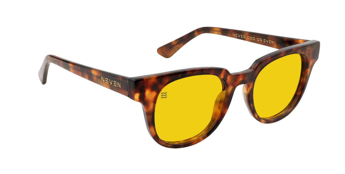 The Neven Eyewear Gryphon sunglasses feature a tortoiseshell brown frame, polarized yellow lenses, "NEVEN" in gold on one arm, and "NEVER ODD OR EVEN" printed inside the other.