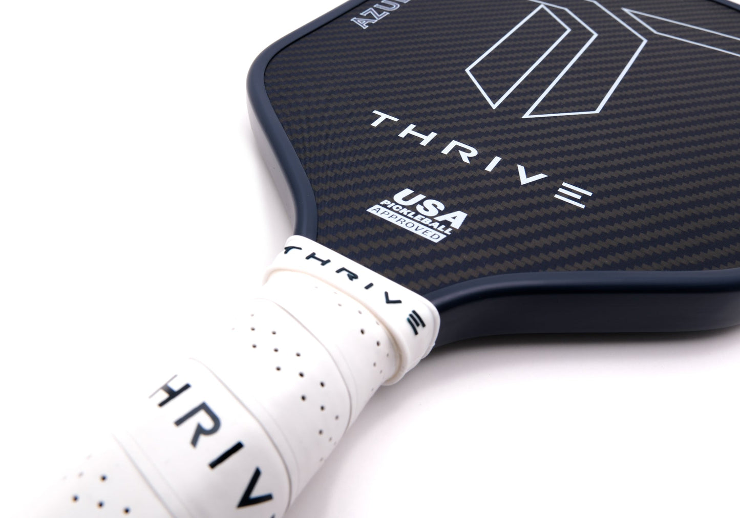 Close-up of the Thrive Pickleball AZUL 16mm (POWER SERIES) paddle in black carbon fiber with white geometric lines, "THRIVE" branding, USA Pickleball Approved mark, and white grip. Includes lead weights, key chain, and weight card. Recommended swing weight: 116-117.