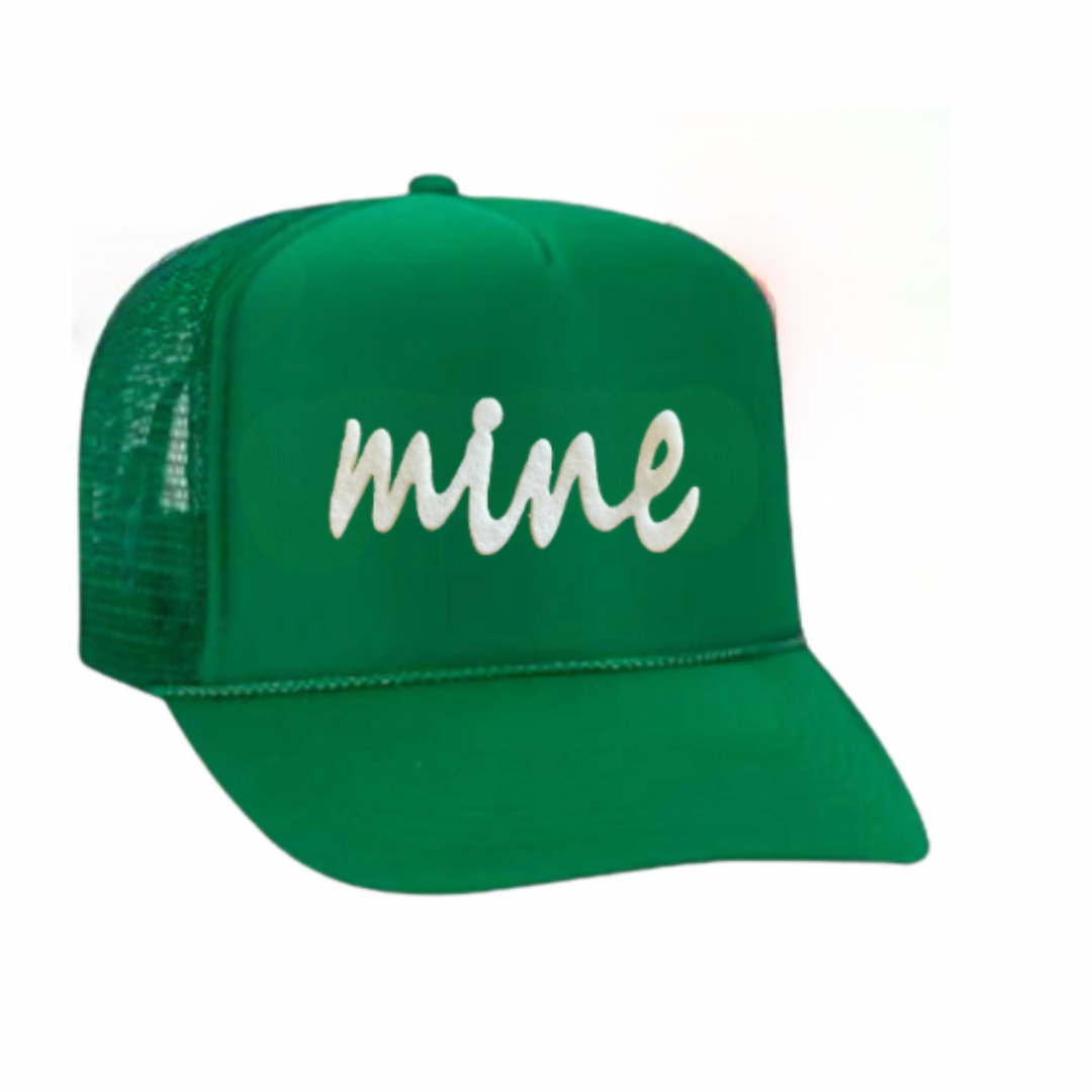 The Yours or Mine Trucker Hat by Runway Athletics features a green mesh design with "mine" in bold white cursive, a curved brim, and structured crown—ideal as a tennis gift for doubles teams.