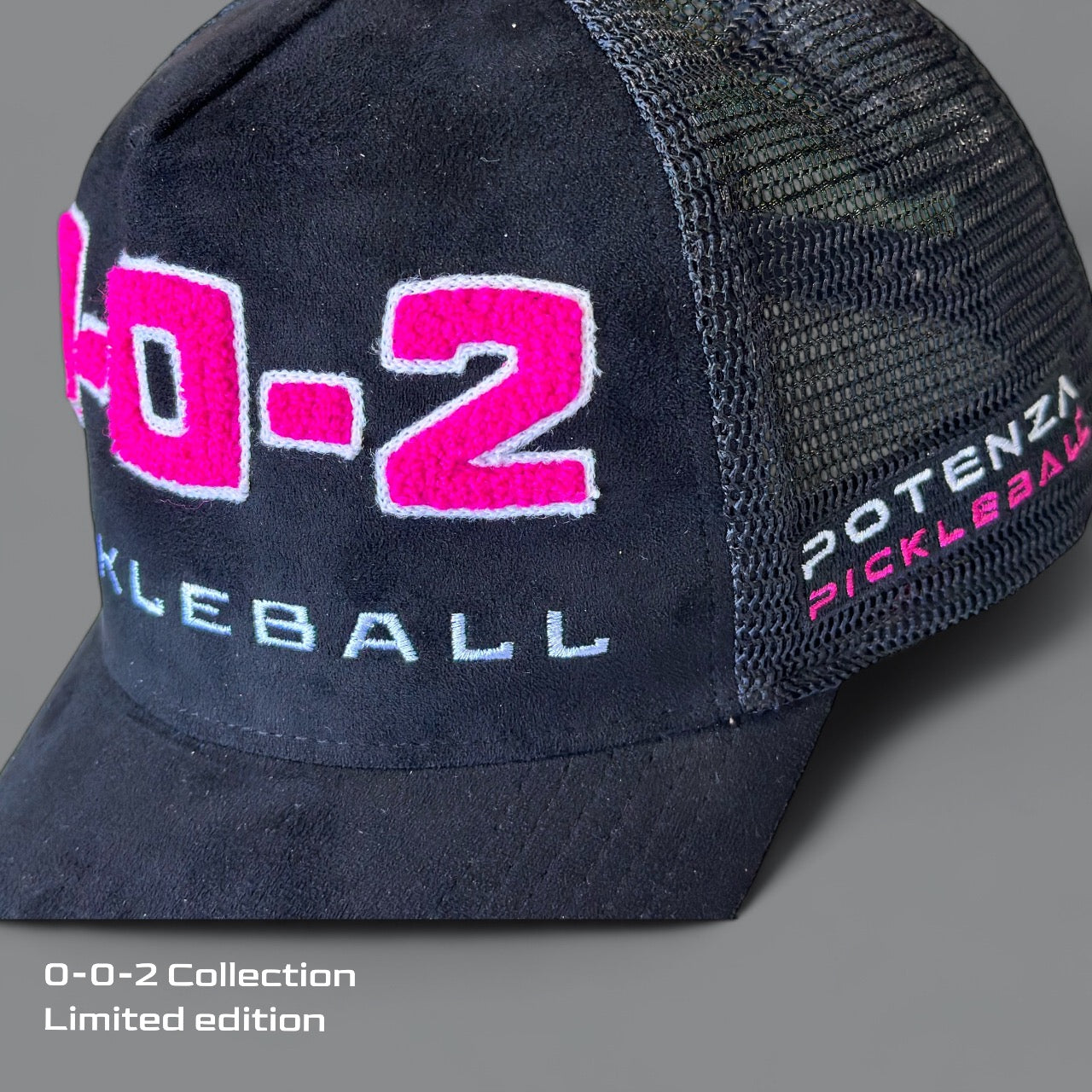 The Potenza Pickleball "0-0-2" Collection Hat (0-0-START) is a limited edition black mesh cap featuring chenille “0-0-2 PICKLEBALL” embroidery in white and pink, with the brand name on the side and “Collection Limited Edition” on the gray corner.
