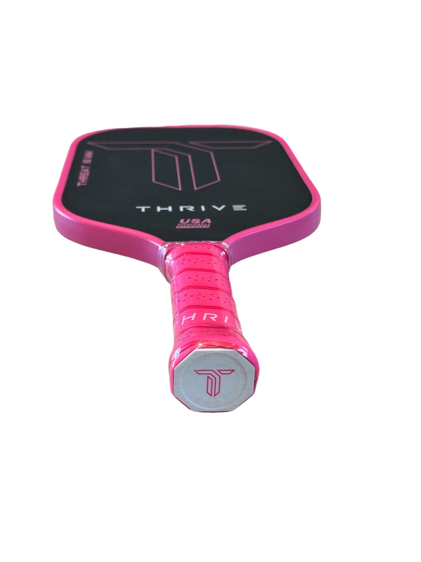 The THREAT 16 (PINK) by Thrive Pickleball is a black carbon fiber paddle with pink edges and handle, spin technology for control, ribbed grip with “T” logo, and comes with a weight card, cover, eraser, and lead weights.