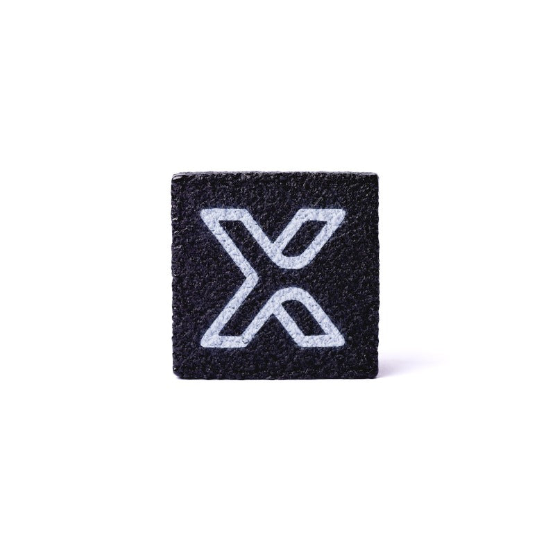 The body helix Pickleball Paddle Eraser and Refresher is a small, black, textured square featuring a white X logo on the front—delivering a minimal, high-contrast look while keeping your paddle clean.