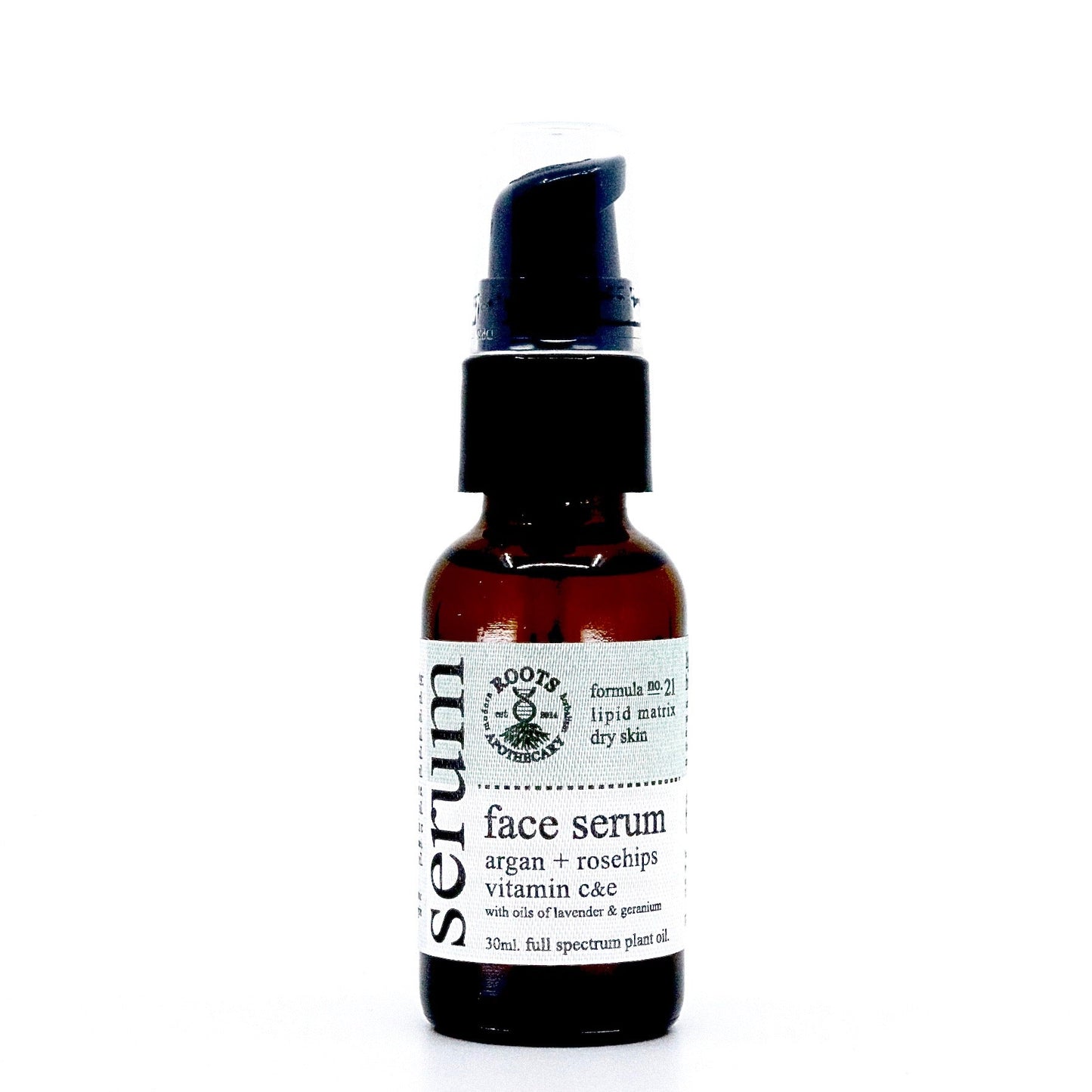 A brown glass bottle with a black pump labeled "Roots Apothecary face serum—unrefined argan oil, rosehips, vitamins C & E, lavender & geranium oils. 30ml." Formulated for dry skin with a nourishing lipid matrix.