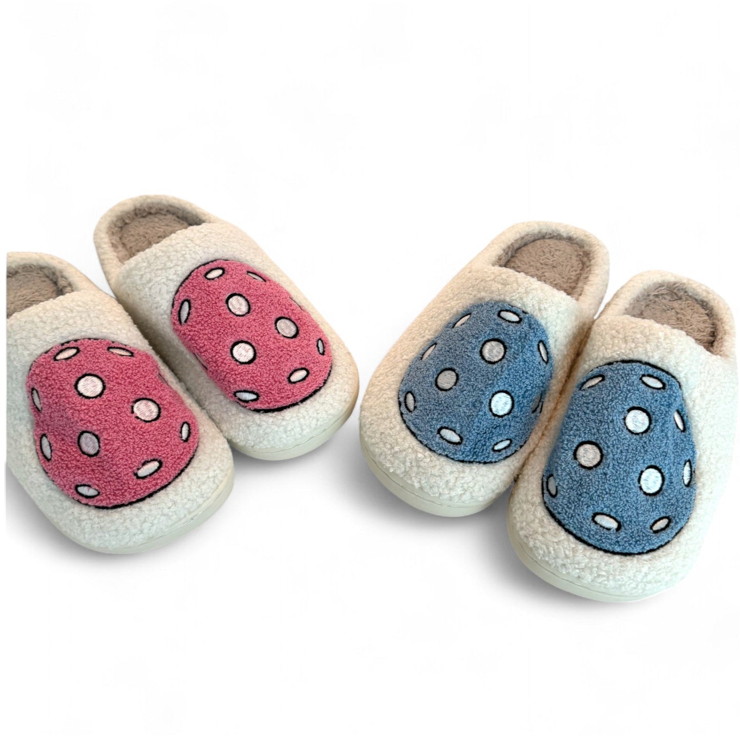 Four pairs of Fresh Pickle Pickleball Slippers are displayed on a white background, featuring cream-colored fuzzy material with either pink polka-dot tops or blue tops—perfect for relaxing in your pickleball pjs.