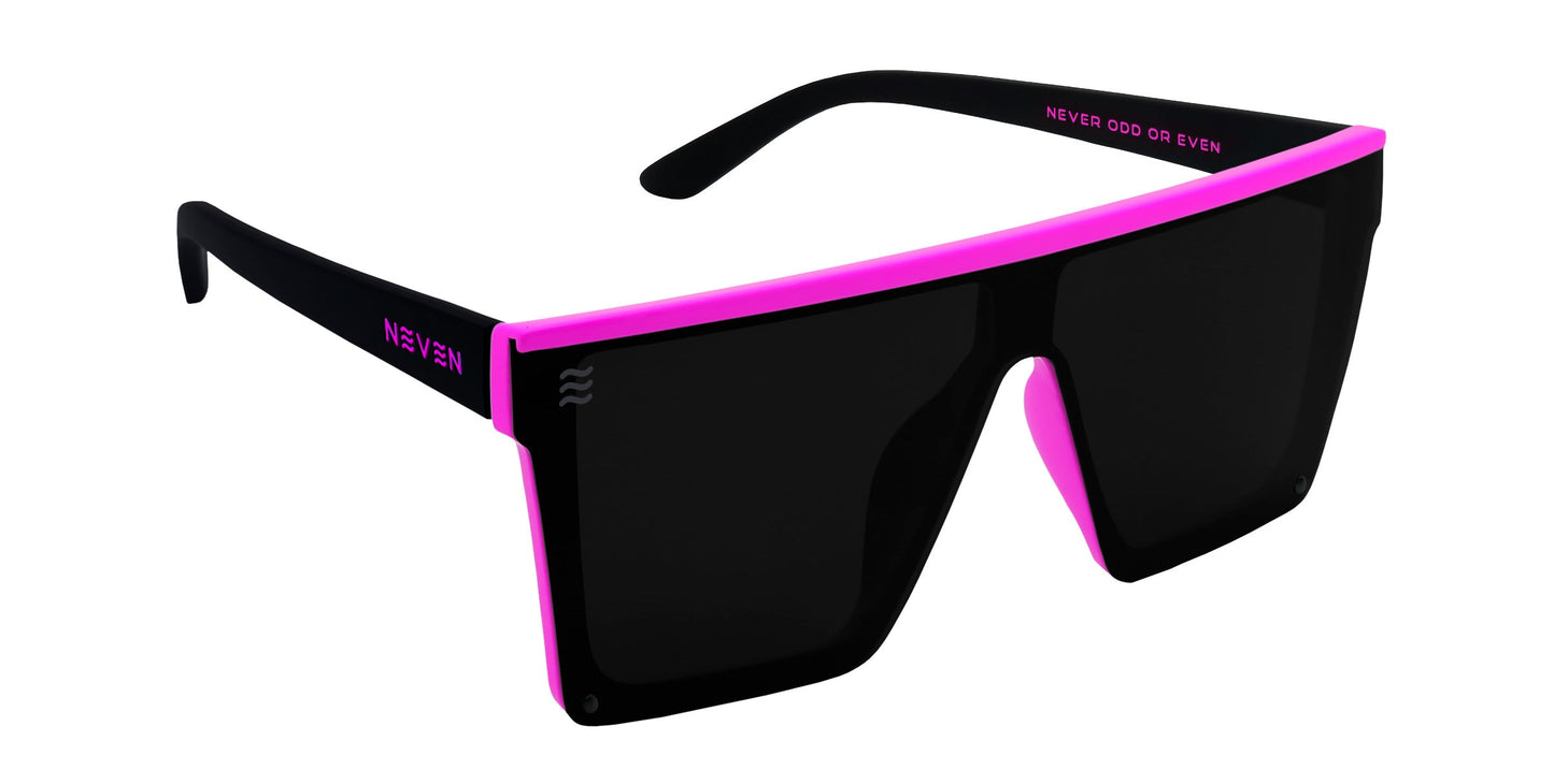 Never Enough by Neven Eyewear: large black boat sunglasses with upgraded TR90 frames and a bold flat top rim highlighted by a pink outline. Oversized polarized UV400 lenses. “NEVEN” in white on one arm, “NEVER ODD OR EVEN” in pink on the other.