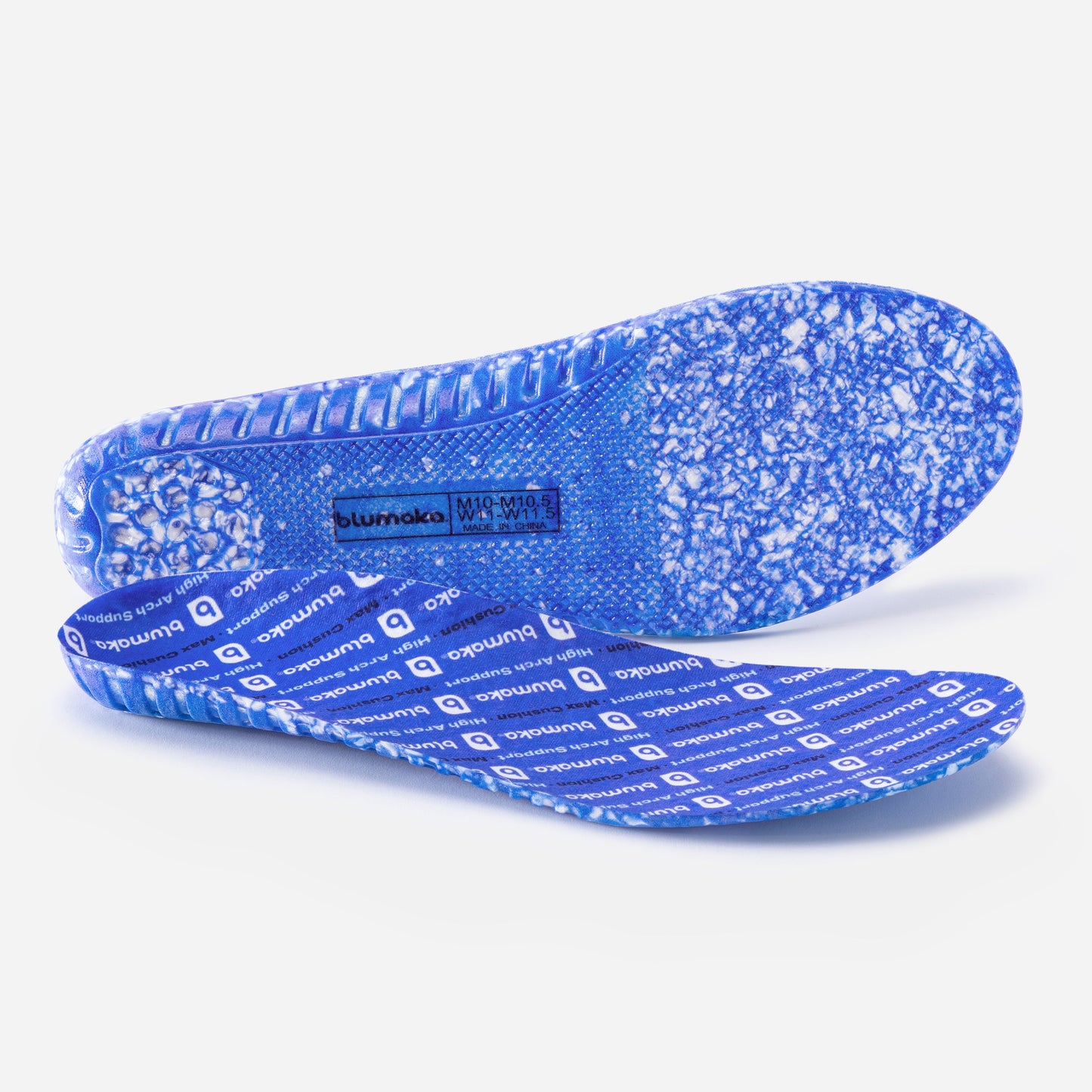 A pair of Blumaka Comfort Insoles are shown on a white background: one lies flat, displaying a marbled shock-absorbing sole, while the other stands upright with repeating Blumaka logos on its top surface.