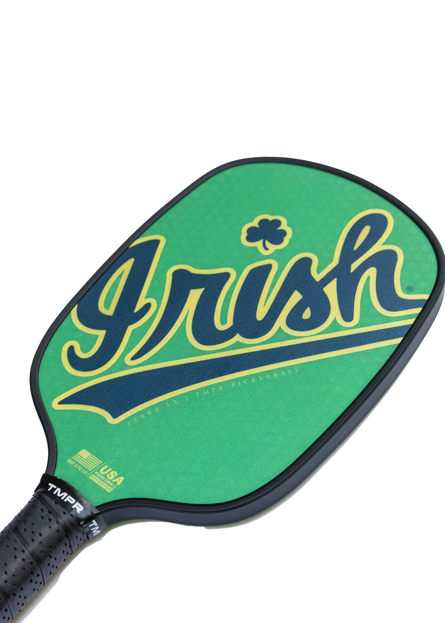 The TMPR Sports Terra LX "Luck of the Irish" pickleball paddle features a green design with "Irish" in bold yellow and navy script, a shamrock above the “r,” a SPINGRIP surface, black textured grip, and official logos near the base.