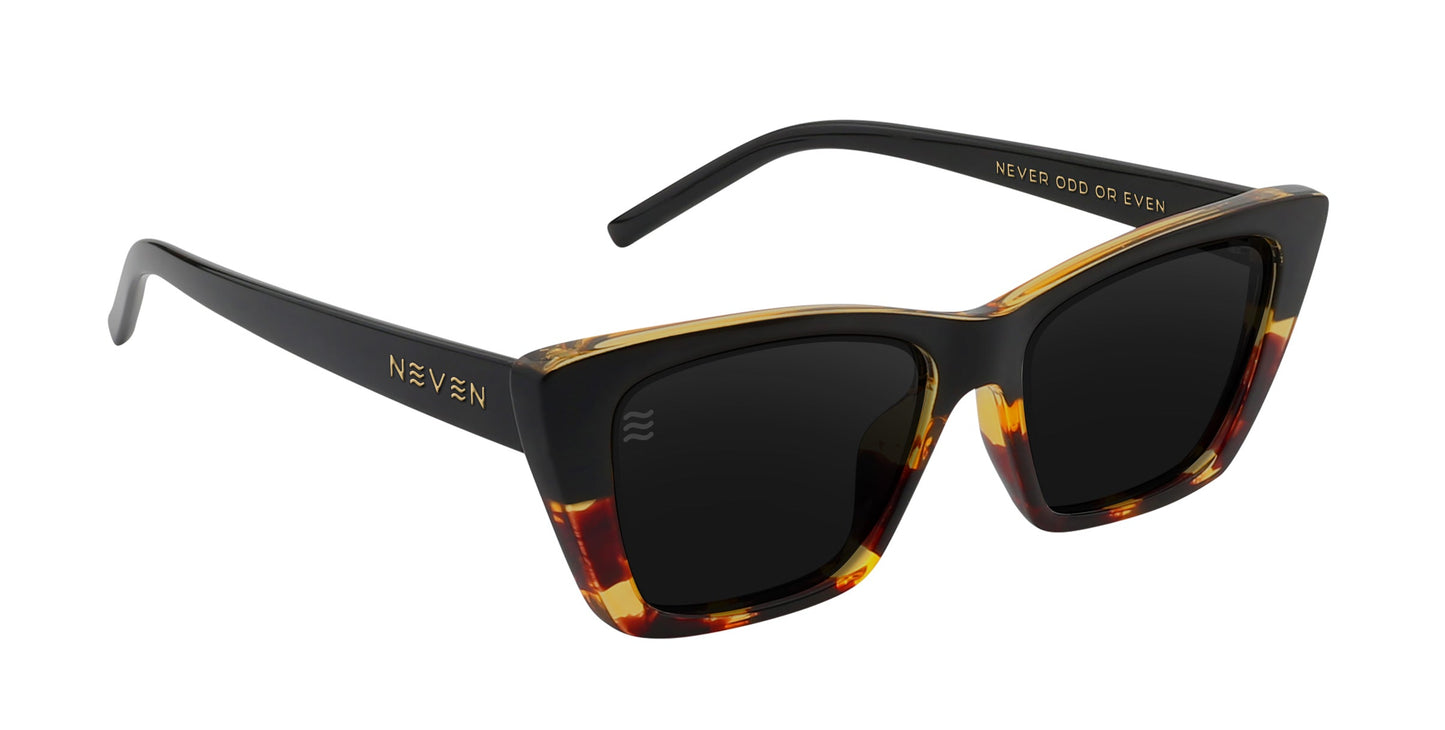 Neven Eyewear’s Dusk sunglasses feature a black tortoise frame with marbled brown-amber patterns, dark polarized UV400 lenses, gold “NEVEN” and “NEVER ODD OR EVEN” on the arms, and a subtle wave logo for a stylish look.
