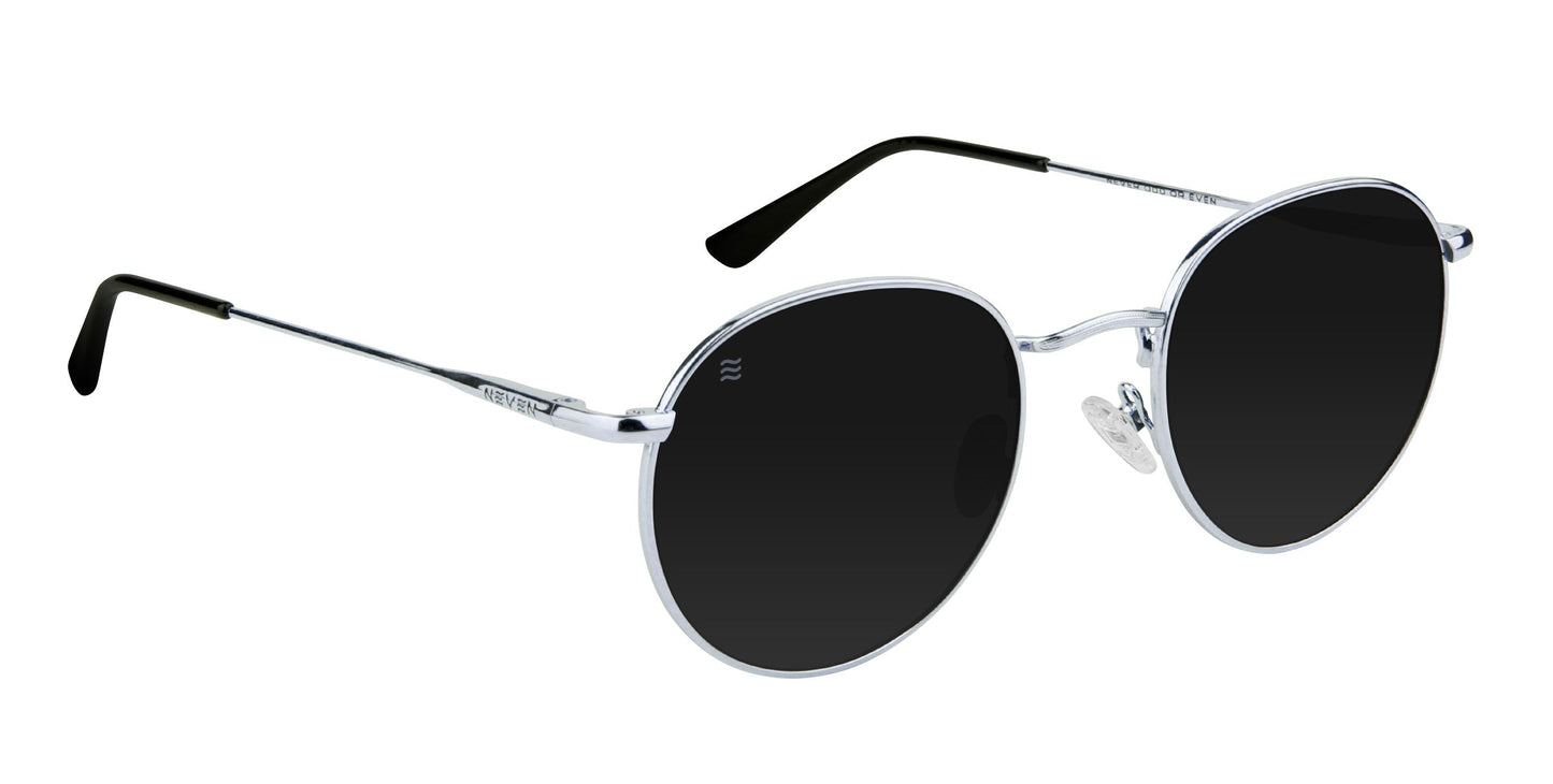Ivy by Neven Eyewear features round sunglasses with thin stainless steel frames, black polarized UV400 lenses, adjustable nose pads, and black plastic tips. Sleek straight arms create a modern look against a plain white background.