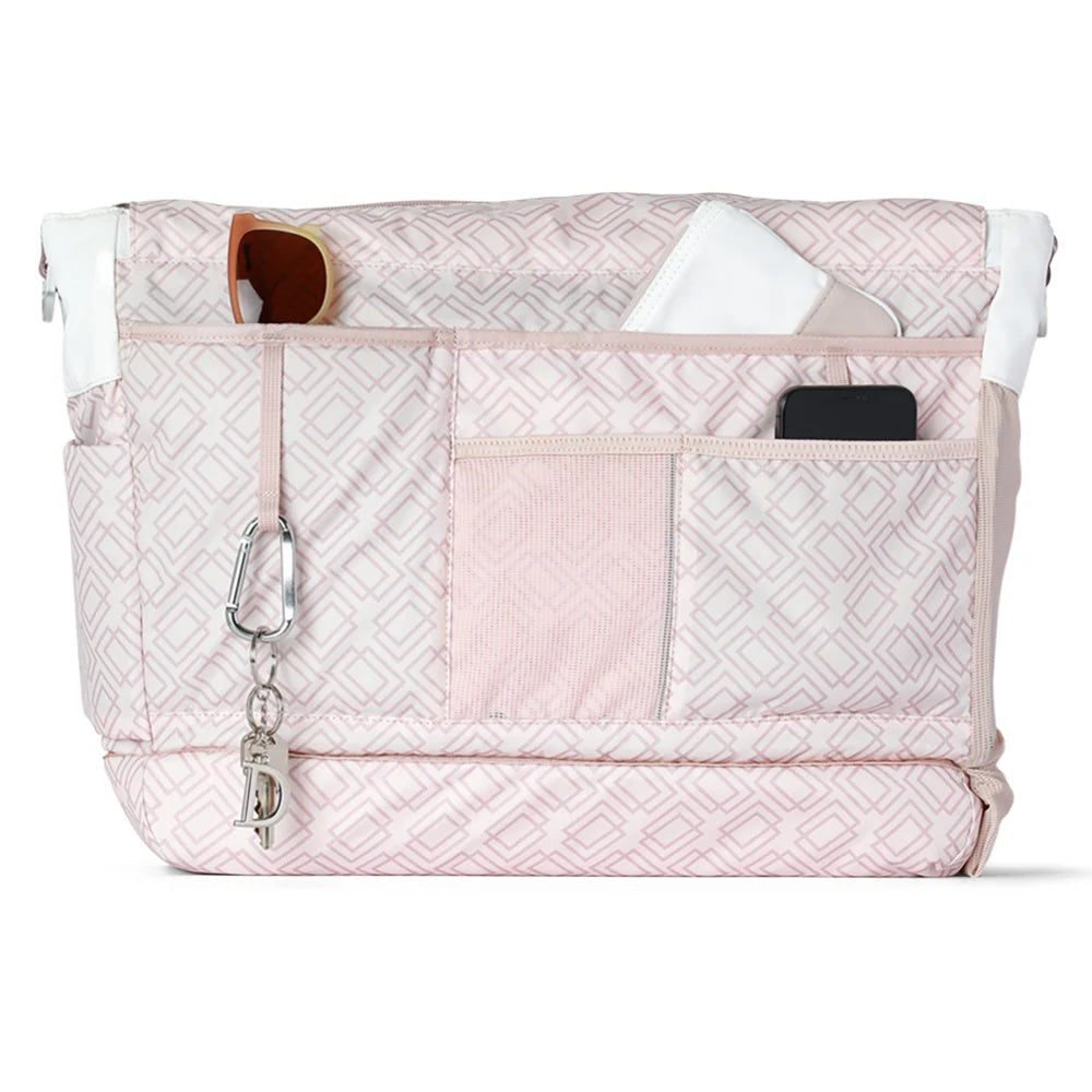 The Doubletake PARISII Pickleball Tote features a pink and white pattern, multiple exterior pockets for sunglasses, a cloth, and smartphone, plus white accents. A silver carabiner with charms decorates the organized design.