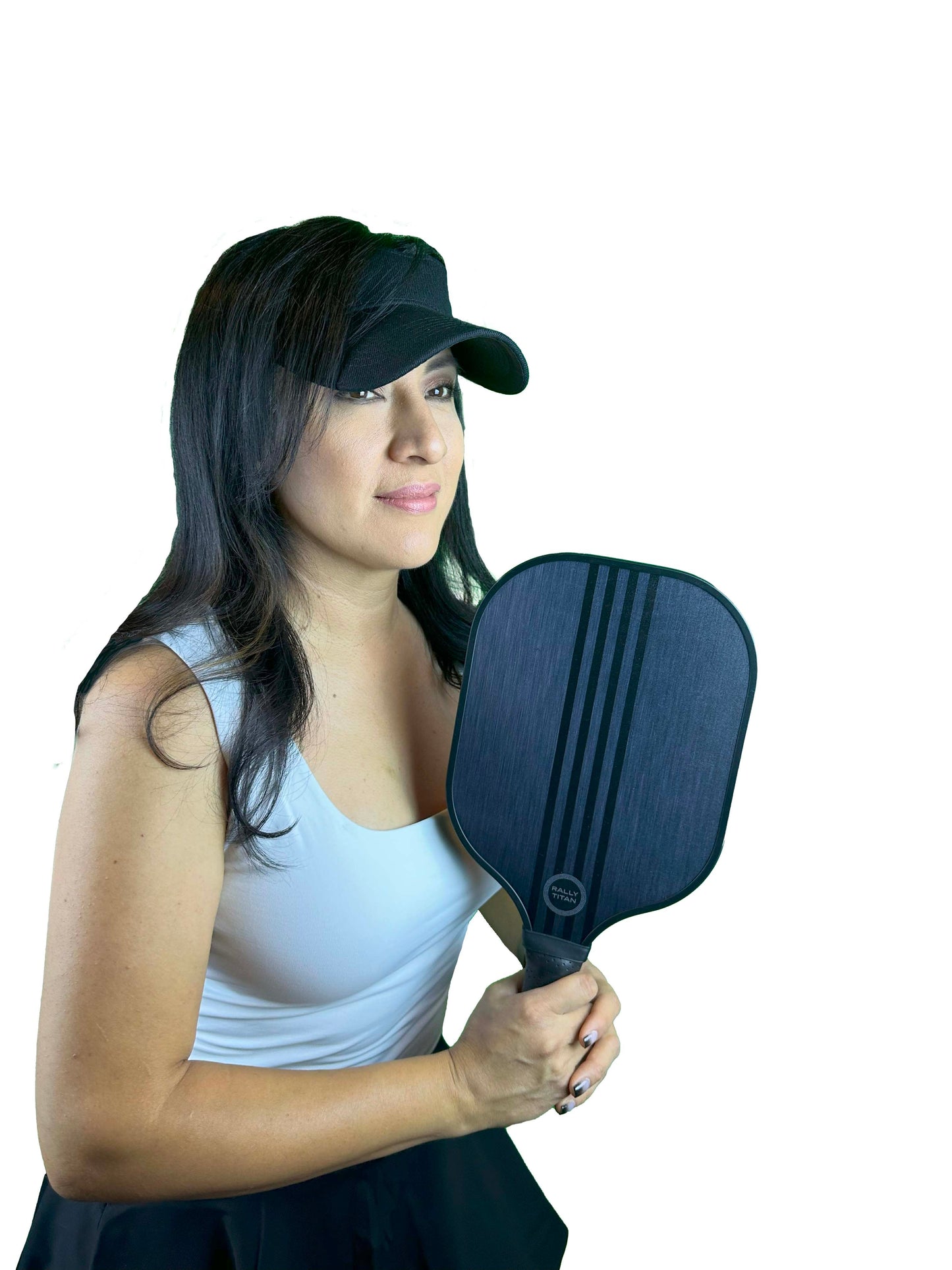 A woman with long dark hair wears a black visor, white tank top, and black skirt while holding the Rally Titan Pickleball Mavro | 10MM paddle, featuring a T300 textured carbon fiber surface, against a plain white background.