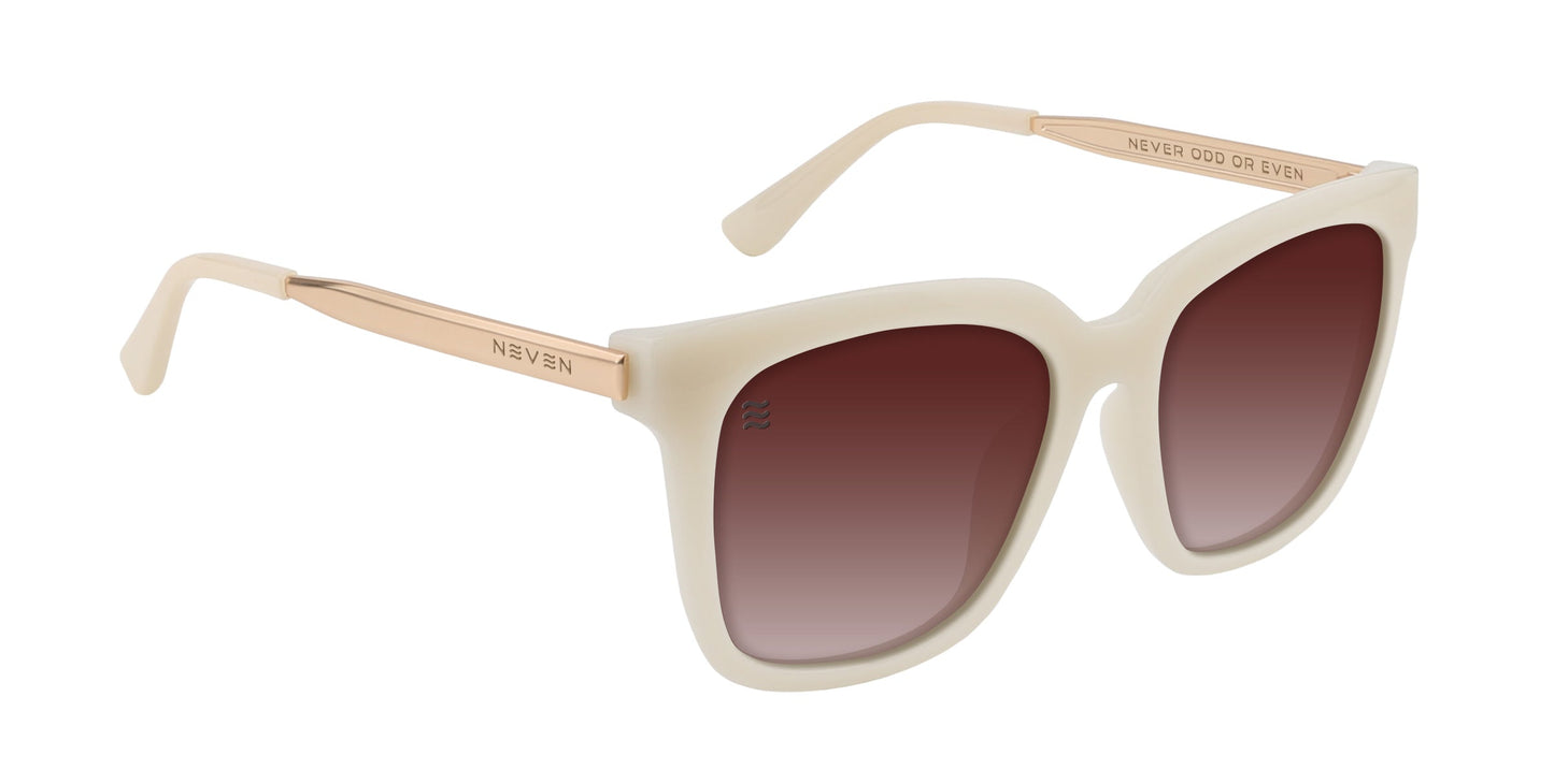 Neven Eyewear's Sand Dollar shades feature square, cream-colored frames with rose gold arms and gradient polarized lenses that fade from dark brown to light. "NEVER ODD OR EVEN" is engraved on the inner arm.