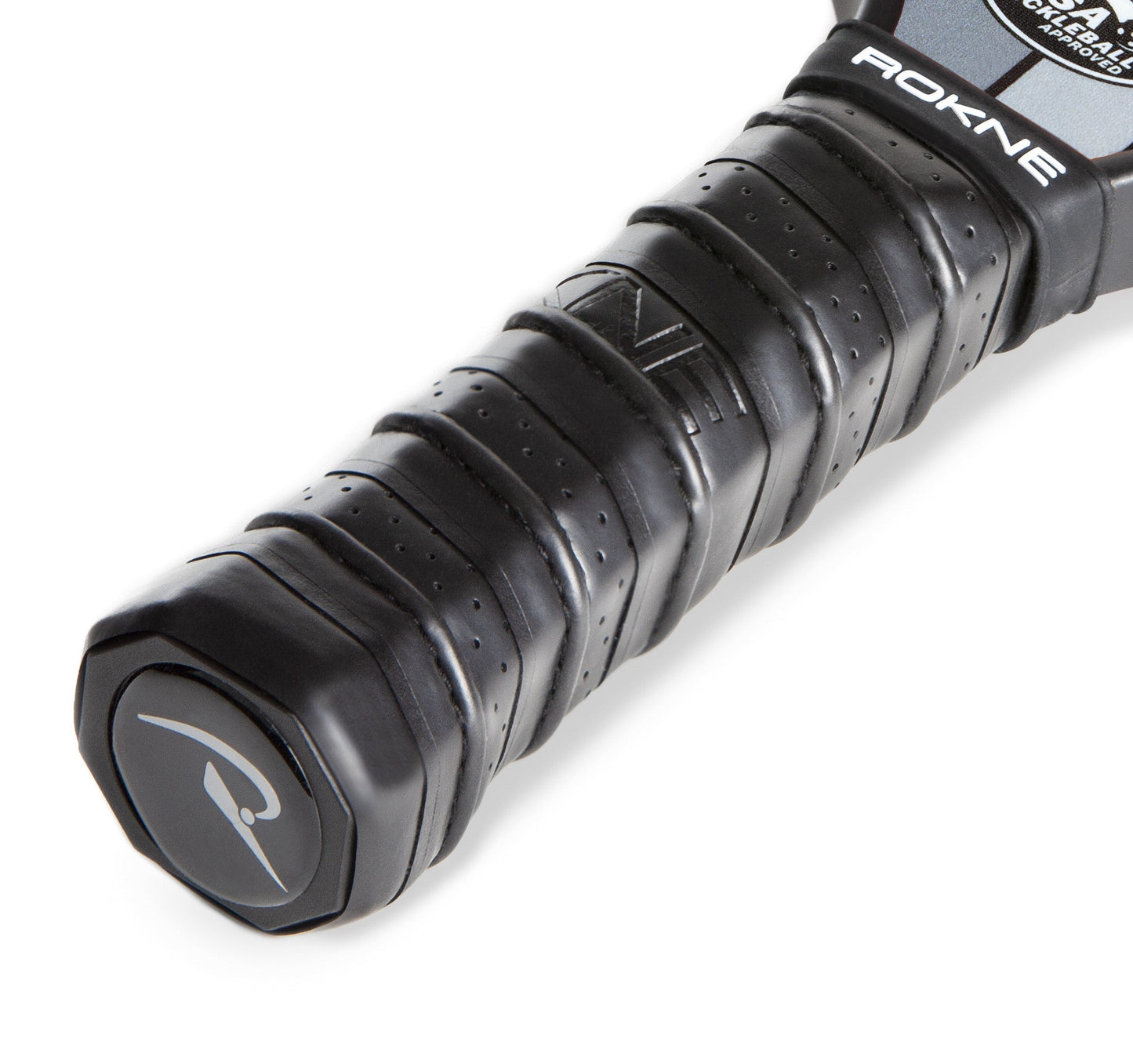 Close-up of the ROKNE REPLACEMENT GRIP, a black textured handle for sports paddles with cushioned comfort, embossed lines, "ROKNE" branding near the top, and a logo on the end cap.