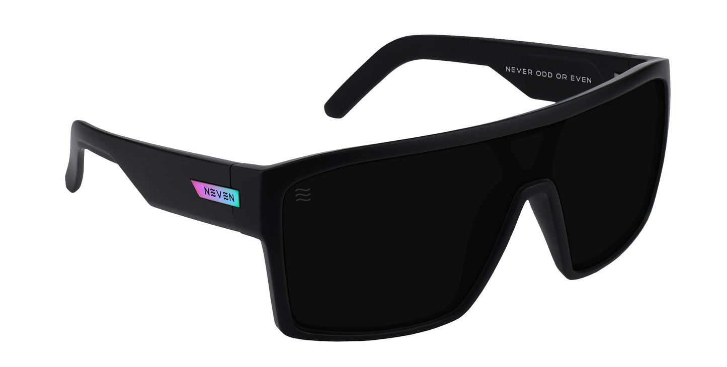 RC's by Neven Eyewear are black, rectangular wraparound polarized sunglasses with thick frames and dark lenses. The left temple has a small iridescent “NEVR ODD OR EVEN” label. Impact-resistant lenses provide durability and clarity.