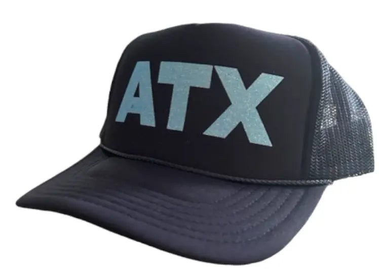 The Runway Athletics ATX Navy Trucker - Baby Blue Sparkle features breathable mesh sides, a curved bill, bold baby blue ATX lettering, and a braided rope detail—perfect sun protection for staying cool outdoors.