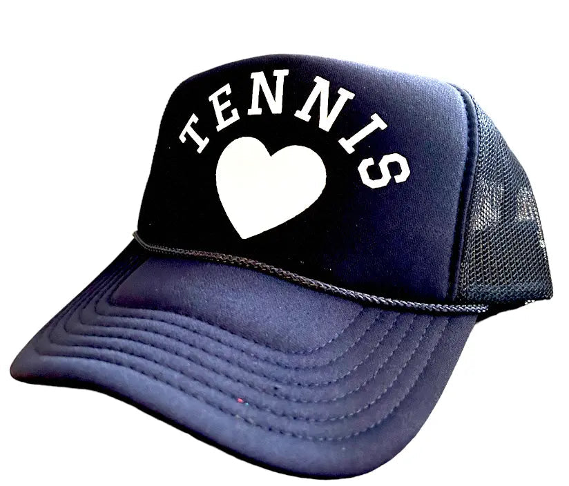 The Runway Athletics Tennis Heart Trucker Hat - Navy/White features “TENNIS” and a white heart on the front, visible brim stitching, and mesh back for ventilation—offering both style and sun protection. The background is white.