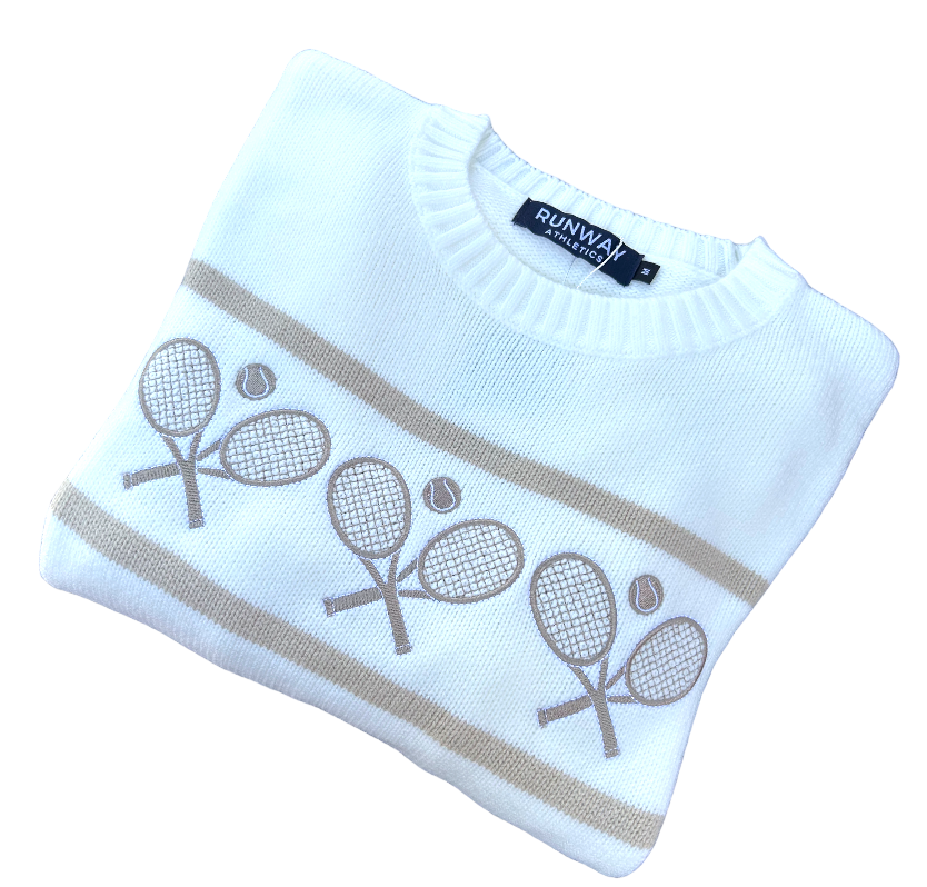 The Tennis Racquets Sweater in cream/camel by Runway Athletics features beige stripes, a crew neck, three pairs of embroidered tennis racquets with balls, and a navy "RUNWAY COLLECTION" tag on the collar. Set against a white background.