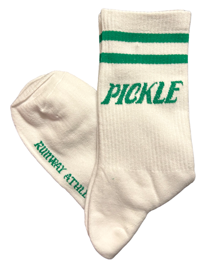 The Pickleball Socks-PICKLE by Runway Athletics are white cotton crew socks with two green stripes. One sock reads "PICKLE" in green; the other features "KUNGFU & FULL" on the foot—a quirky athletic style for sporty looks.