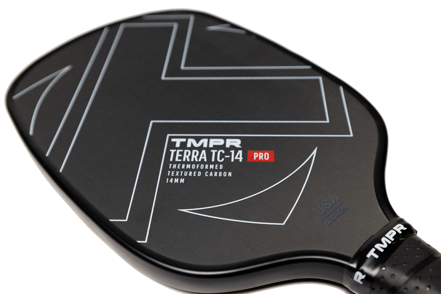 Close-up of the TMPR Sports Terra TC-14 Pro pickleball paddle in black with geometric lines and bold branding. Features a 14mm thermoformed textured carbon face, honeycomb poly core, and USA Pickleball certification by the handle.