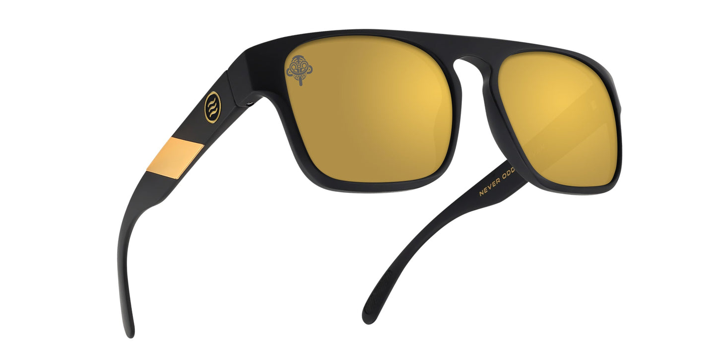 Neven Eyewear's Golden Banana sunglasses feature a matte black frame, large gold-mirrored square lenses, a gold accent, and "MM" on the left arm. Polarized UV400 protection keeps your eyes safe and stylish everywhere.