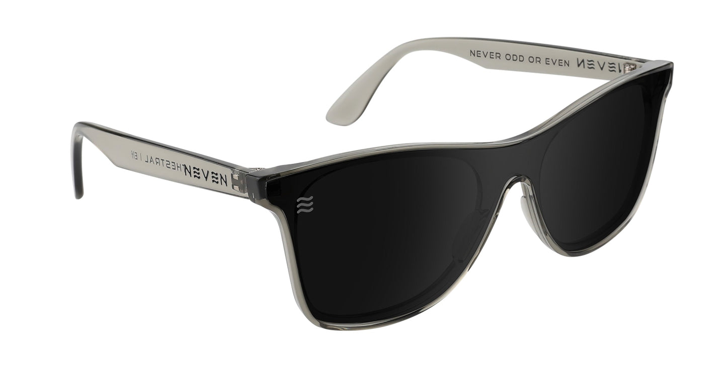 Elf by Neven Eyewear: Large, rounded black-lens sunglasses with transparent gray frames from the Thestral Collection, featuring UV400 polarized lenses and temples with “NEVER ODD OR EVEN” and “NEVEN” for a bold modern style.