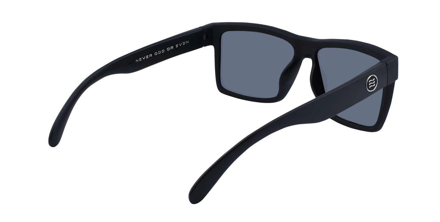 A pair of black rectangular Neven Eyewear Ace sunglasses viewed from the back, featuring gray polarized UV400 lenses, subtly curved arms, a white circular logo on the right arm, and "NEVER ODD OR EVEN" on the inner left arm.