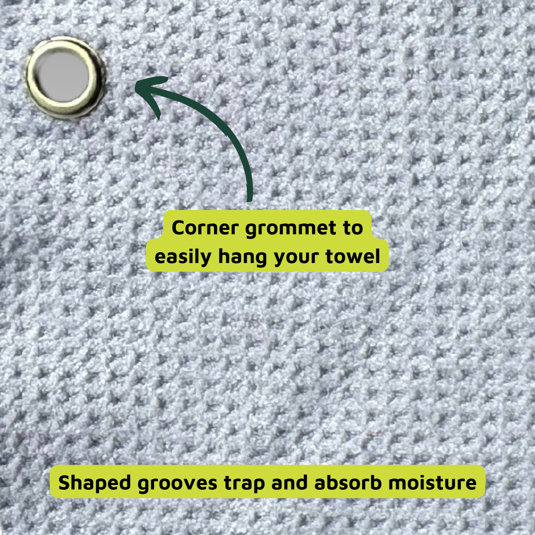 The Playly Store Two-Bounce Towel features pale gray microfiber waffle weave with textured grooves to trap moisture. A metal grommet in the corner makes it easy to hang from your golf bag for convenient sweat absorption.