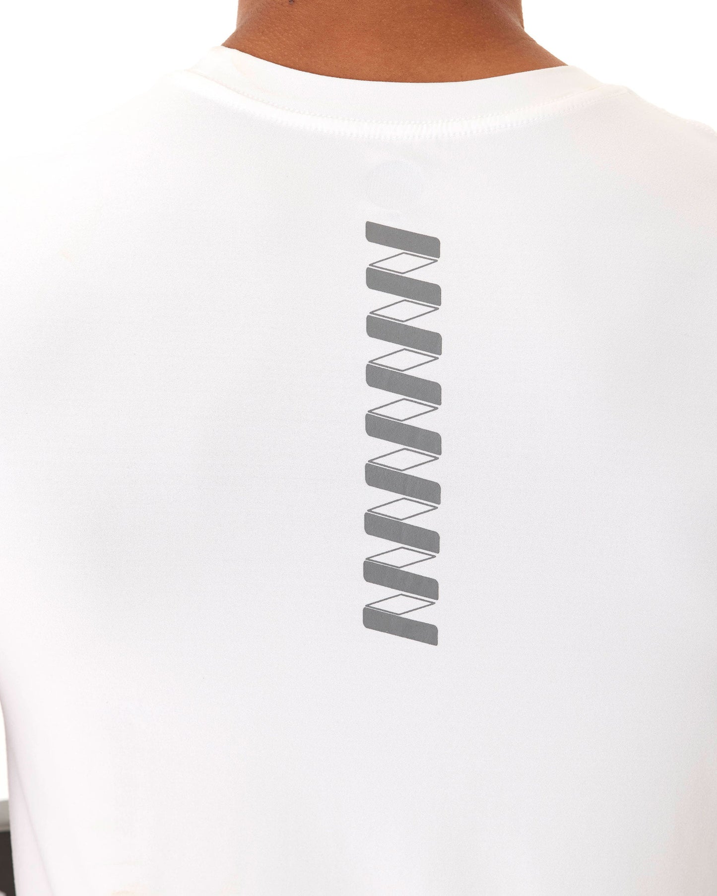 A man is seen from behind wearing the Wringer Wear Men's Short Sleeve WRINGER T-shirt, featuring a vertical row of gray rectangular and diagonal designs on the upper back. The athletic-fit, breathable fabric pops against a plain white background.