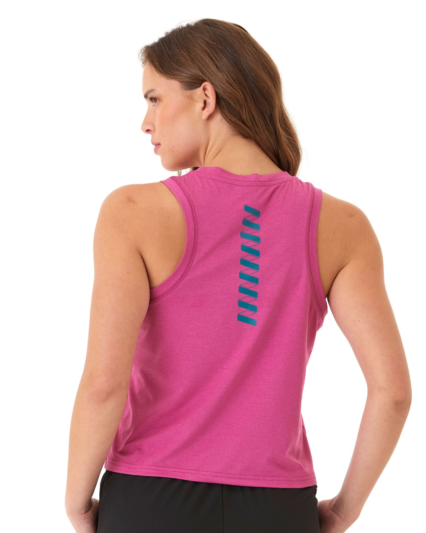 A woman with long brown hair wears the Wringer Wear Women's Performance Wringer Tank in magenta with a vertical blue zigzag on the back, paired with black shorts. She stands facing away against a plain white background.