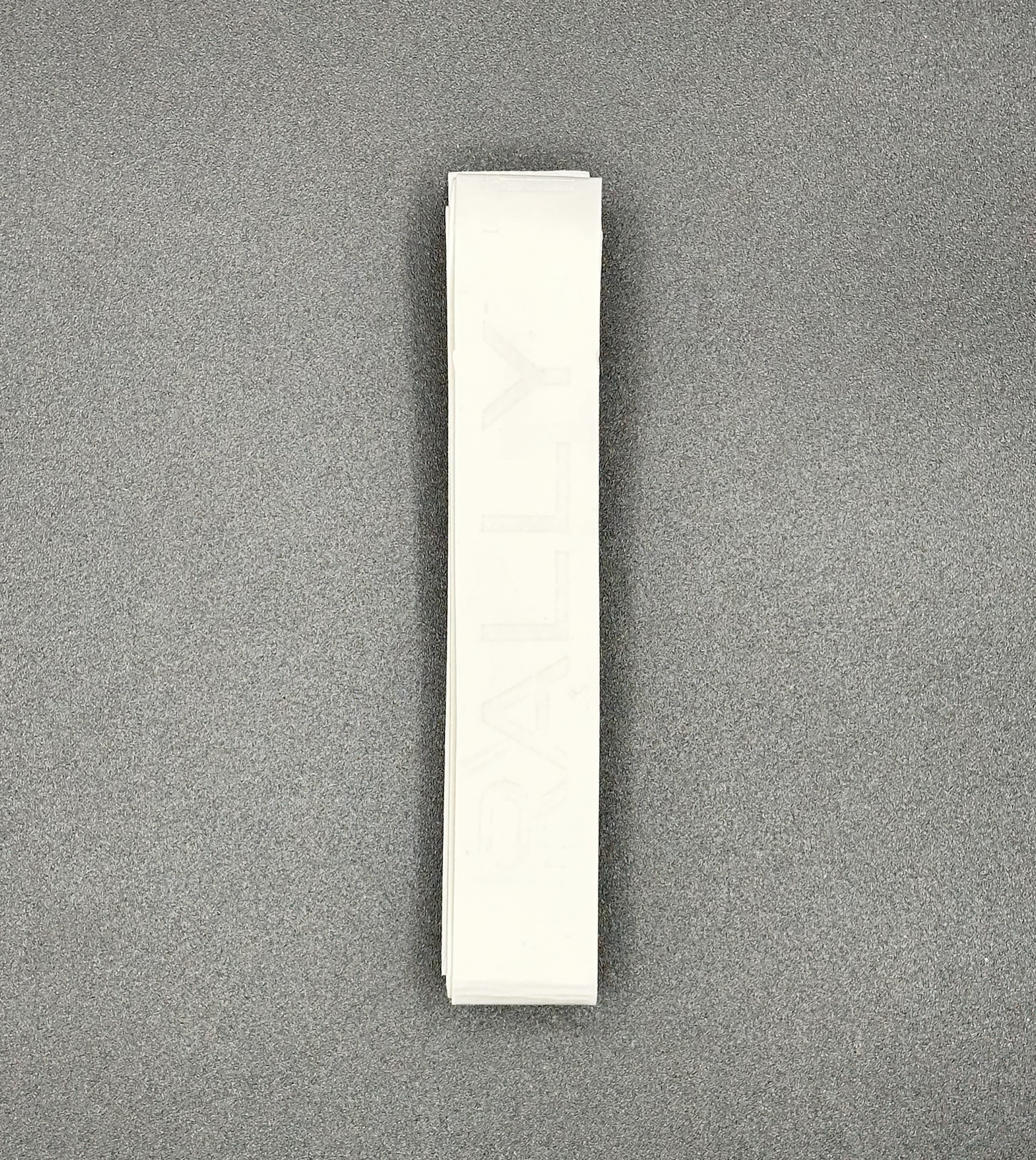 A stack of white Rally Titan Pickleball Over Grips is arranged vertically on a gray textured background. The top grip features the faint, barely visible "RALLY" text in tall, uppercase letters.