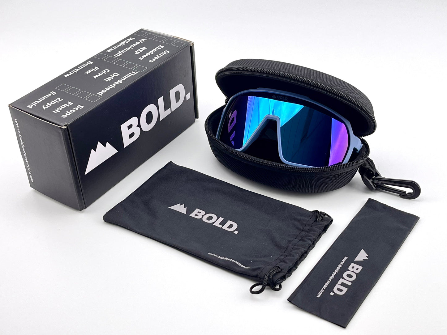 The BOLD Slayers Performance Sunglasses by boldouterwear, featuring blue-mirrored lenses, are displayed with a hard zippered case, branded microfiber pouch, and cleaning cloth beside a box labeled BOLD on a white background.