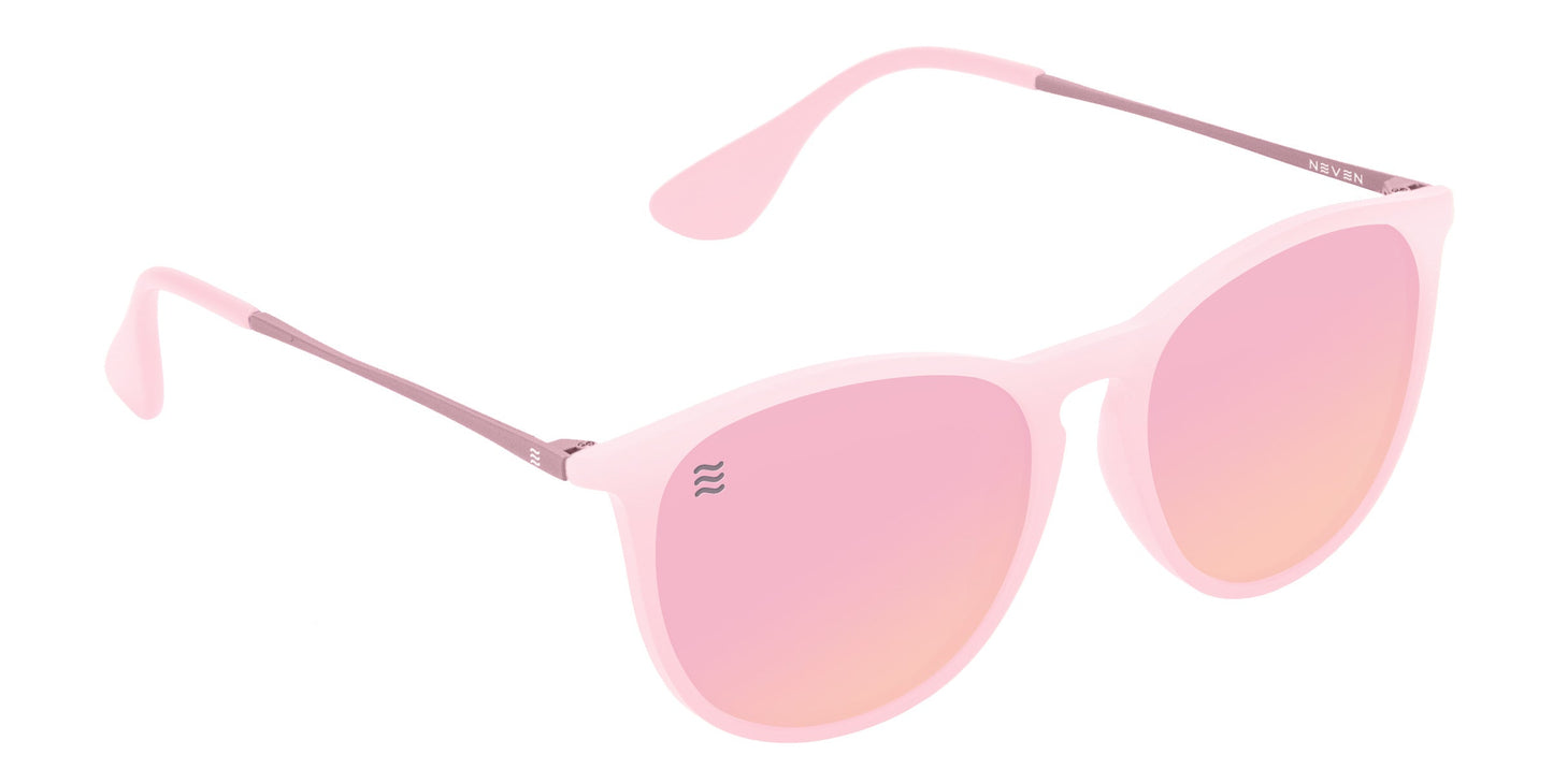 Dreamy by Neven Eyewear features light pink, round-edged frames with matching pink gradient, impact-resistant lenses. Slim pink arms offer comfort, while a subtle silver wave logo accents one lens.