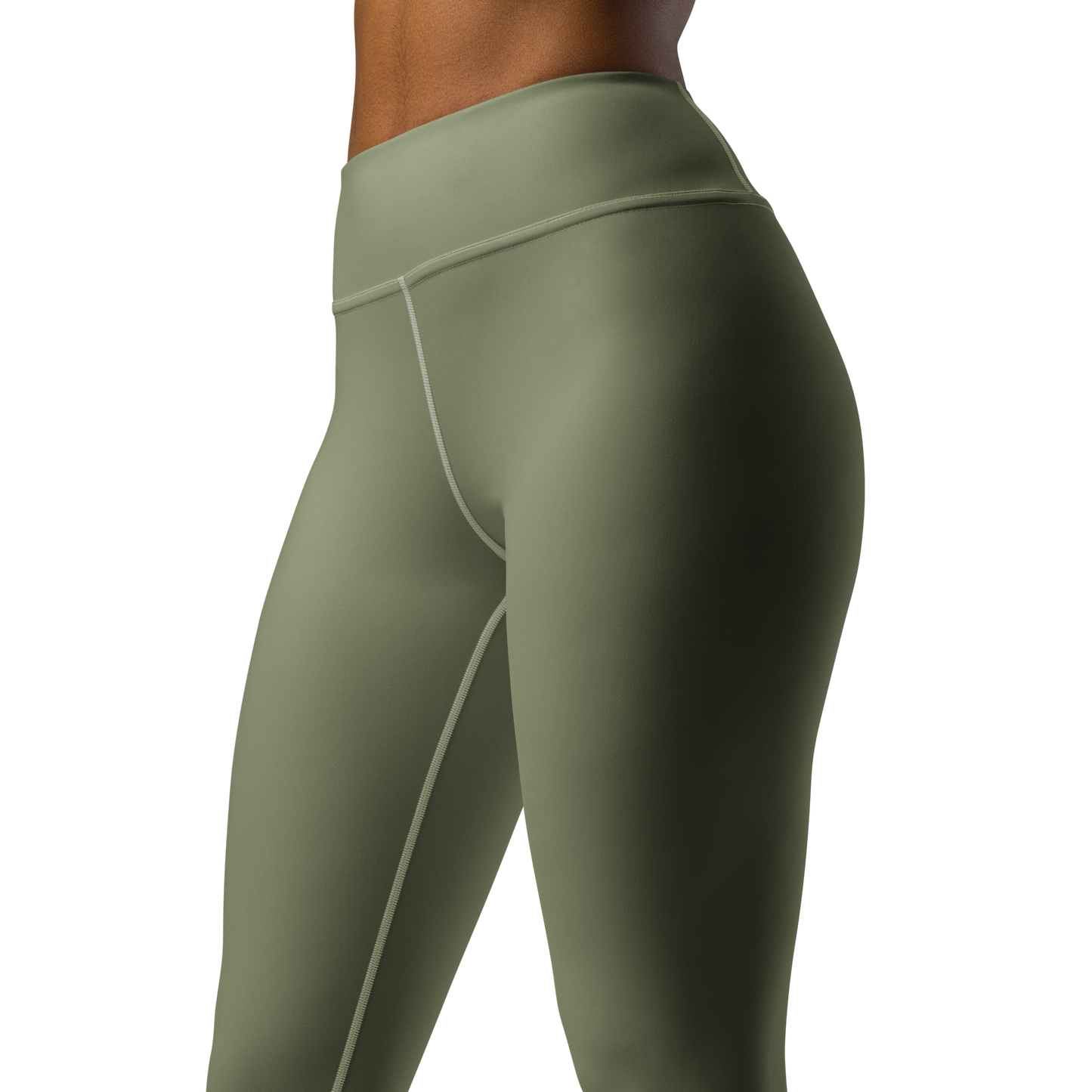 A close-up of a person wearing CROWN PICKLEBALL - High-performance Leggings (Olive) by Crown Pickleball, featuring a high-waisted fit, matte finish, and curved seams. The plain white background highlights their comfort and sleek style.
