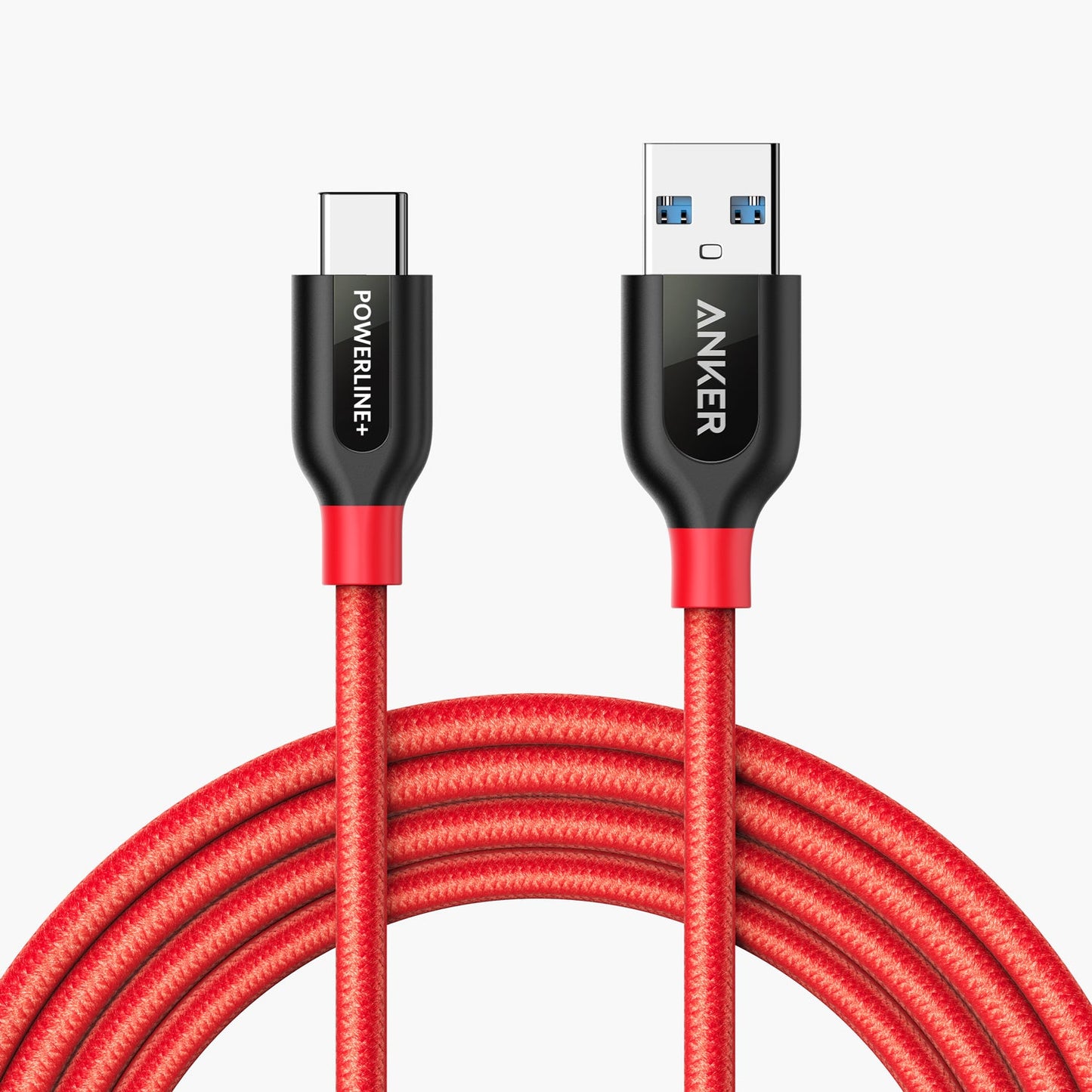 A red braided Anker Powerline+ USB C to USB 3.0 Cable (3 ft, 6 ft) with black and red-accented connectors—USB-A labeled ANKER and USB-C labeled POWERLINE+—is coiled neatly against a white background.