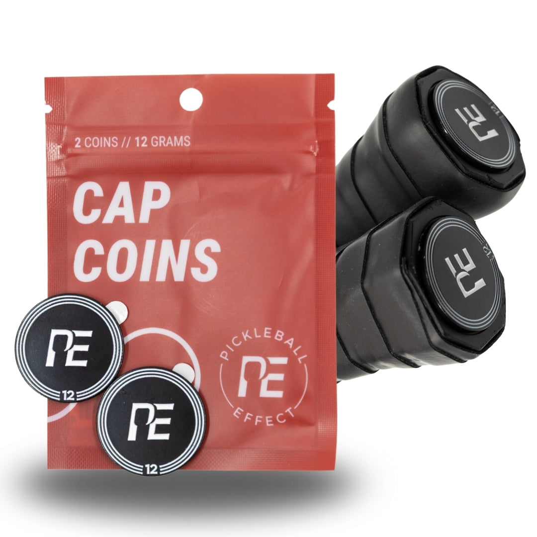 A red Cap Coins pouch from Pickleball Effect Shop sits next to two black paddle grips and two round black coins, each with a white PE logo and number 12—ideal for adjusting pickleball paddle balance or customizing weight.