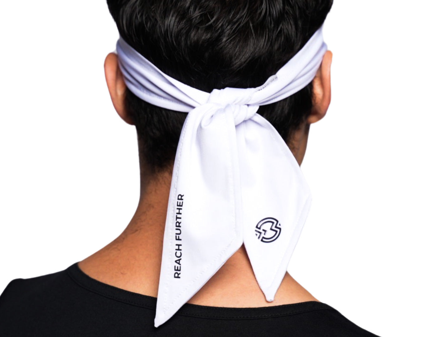 A person is seen from behind wearing a Massov Headband Tie, featuring “REACH FURTHER” printed on one tail and a round black logo on the other, blending sweat-wicking comfort with a minimalist design.