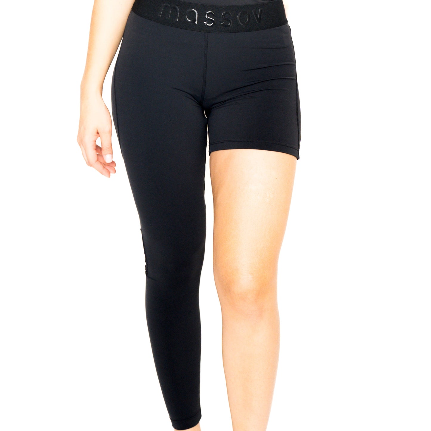 A person models Massov ProForm® Women's One Leg Compression Pants—one side full-length, the other short—with "massov" embossed on the high waistband. Only the lower torso and legs are shown against a white background.