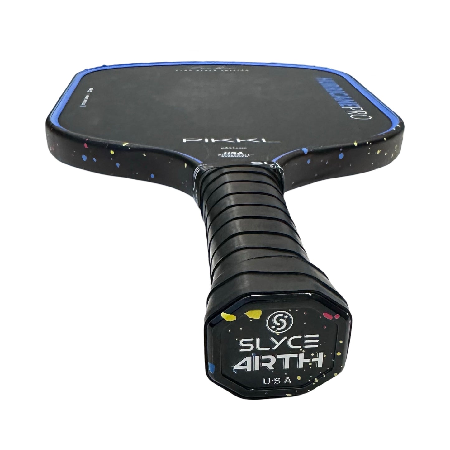 A close-up of the Slyce Sport Special Edition 4rth Pickleball Black/Pink Paint SpeedCap (28g, 1.0 oz.) Paddle Performance Enhancer shows its textured grip, blue outline, pink speckles, "PIKKL" logo, and USA printed beneath "SLYCE ARTH" on the cap.