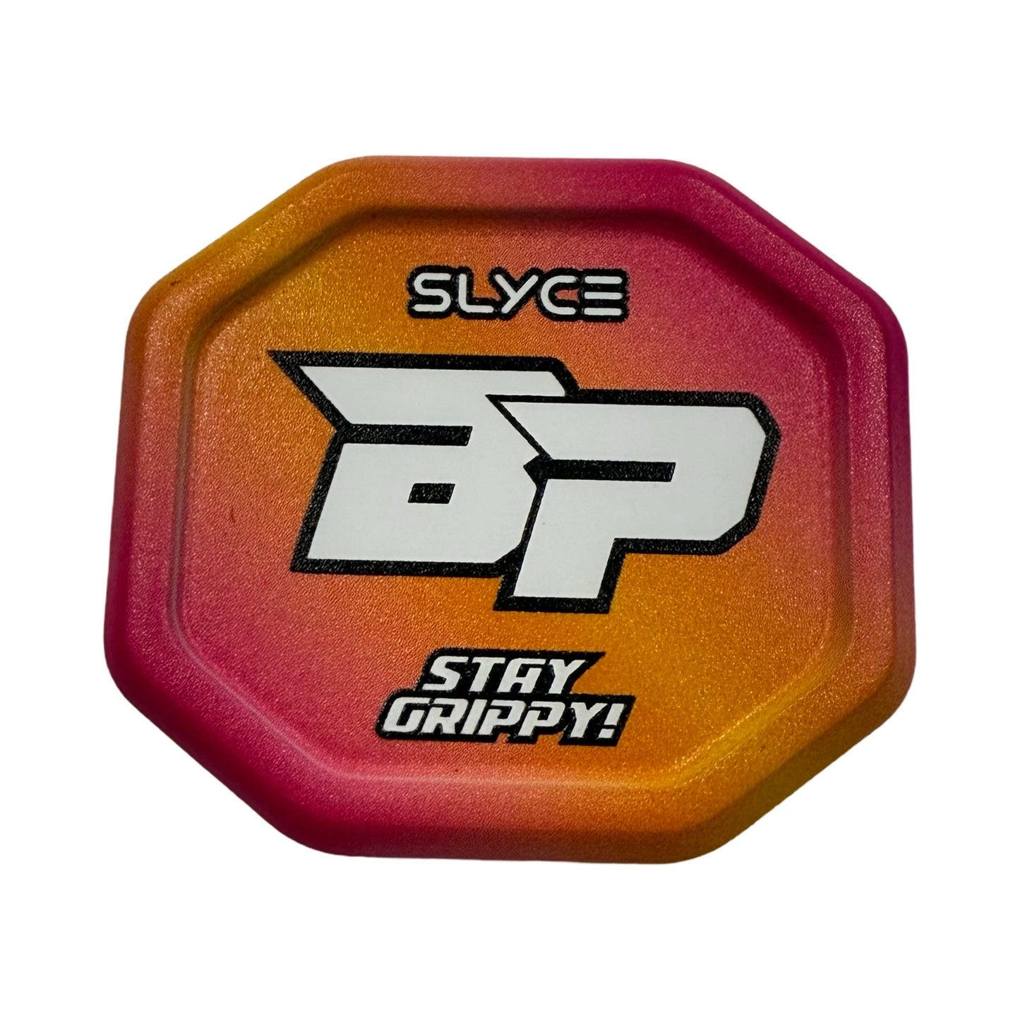 The Slyce Sport Special Edition Bodhi Pickleball Sunset SpeedCap (28g, 1.0 oz.) is an octagonal paddle enhancer with an orange-to-pink gradient, bold white SLYCE at the top, a large BP in the center, and STAY GRIPPY! at the bottom.