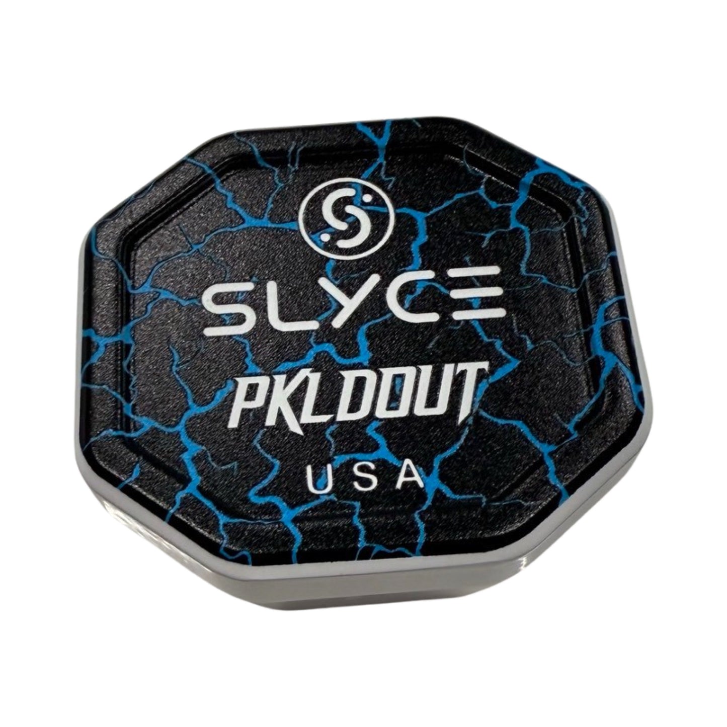 The Slyce Sport Special Edition PKLDOUT Broken Blue SpeedCap is a black, octagonal aircraft aluminum paddle enhancer (28g, 1.0 oz.) with a blue crackle pattern, circular logo, bold white "PKLDOUT," and "USA" on the container against a plain white background.