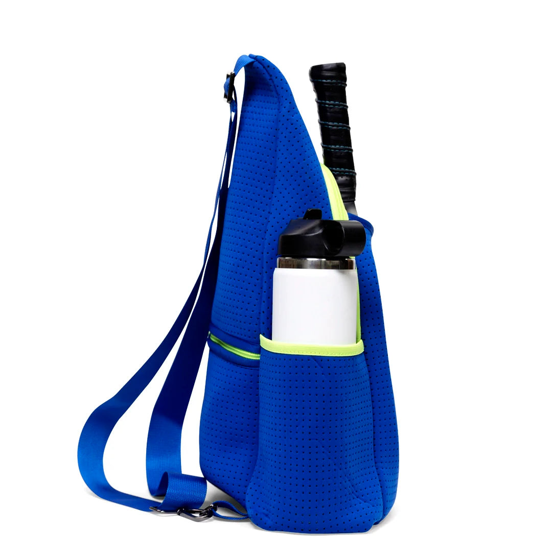 The Swinton Pickleball Pickleball Paddle Sling Bag in royal blue is a neoprene, perforated crossbody with a wide strap, lime green pocket trim, a front pocket for your water bottle, and a main compartment to fit your paddle or racket.