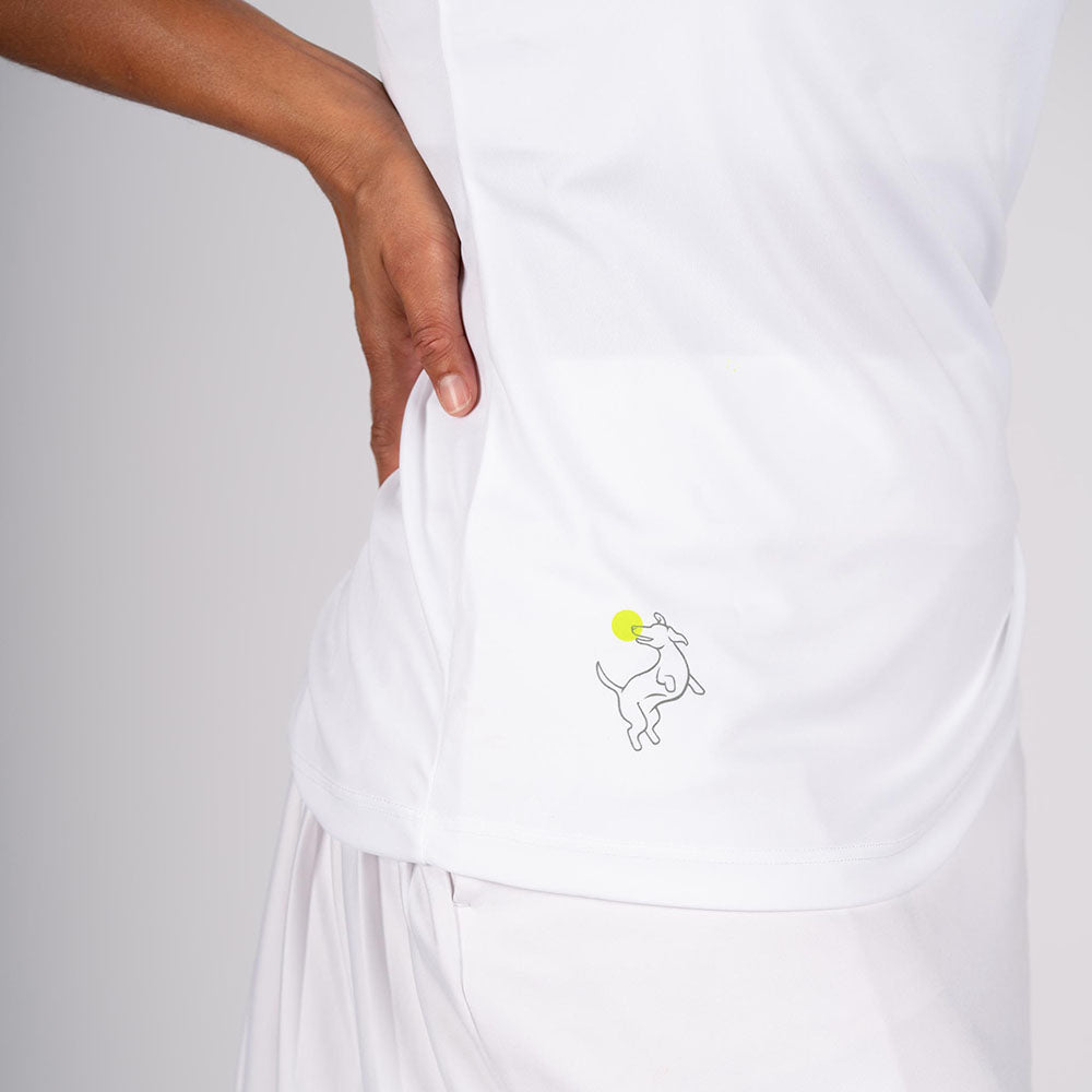 A person in profile wears the Swinton Pickleball Performance Tank White, featuring a small line drawing of a dog leaping for a yellow ball on the side. The background is plain and light-colored.